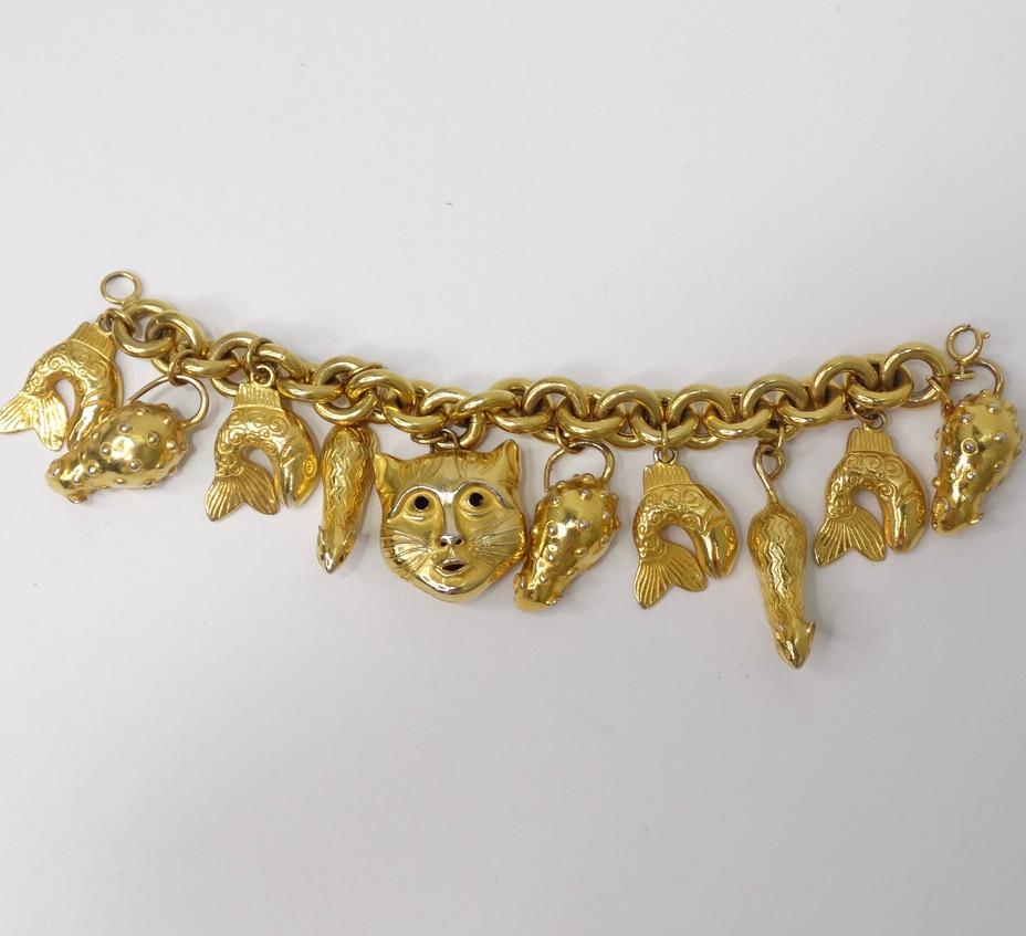 Incredible Isabel Canovas charm bracelet from the 1980's! Super chunky solid gold cat, rabbit and fish charms come together to form the perfect statement piece for any animal lover! Charms feature detailed engravings and stone motifs as the