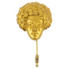 Spilla con volto intagliato in bronzo dorato Isabel Canovas