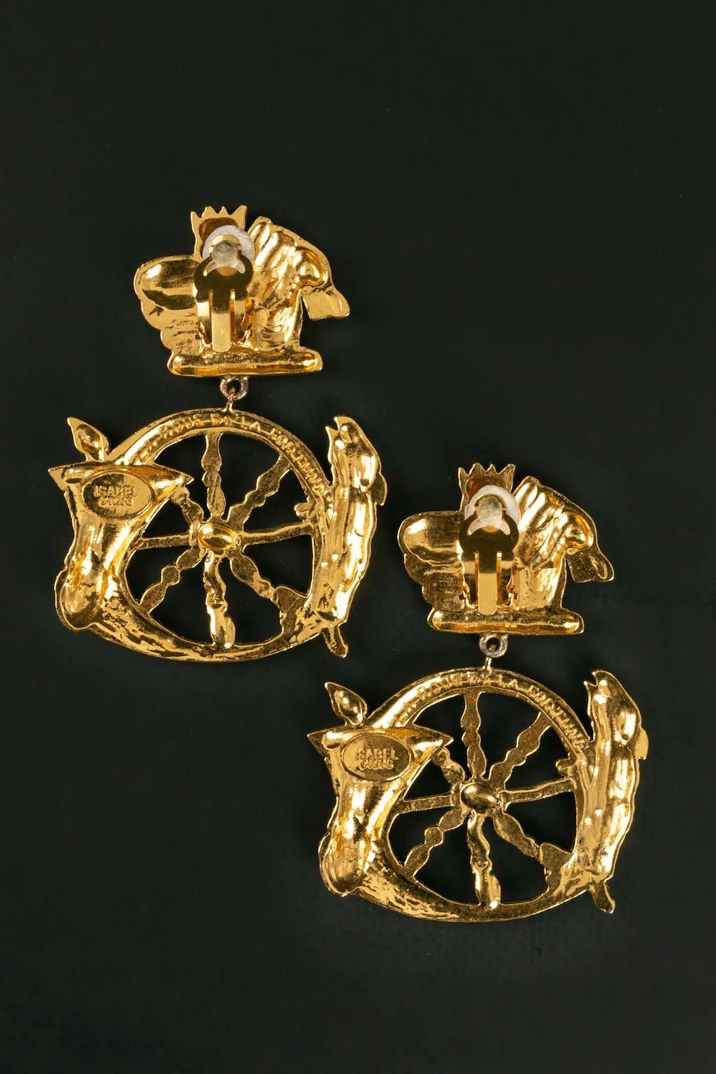 Isabel Canovas -Golden metal earrings on the theme of the wheel of Fortune.

Additional information:
Dimensions: 5 W x 6.5 H cm

Condition: 
Very good condition

Seller Ref number: BO212