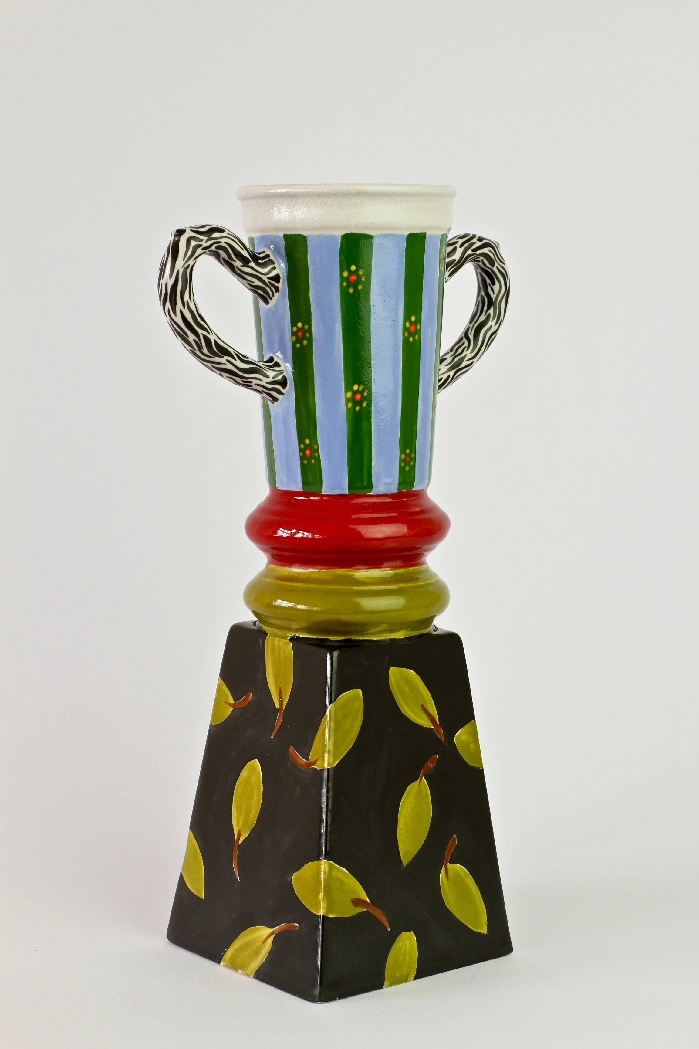 Signed Isabel Klingstein trophy, vase or vessel, circa 1982. A fun and brightly decorated piece very much reminiscent of the style of Italian designers, like Ettore Sottsass for the Memphis Group, in the 1980s.

Brightly decorated, whimsical and