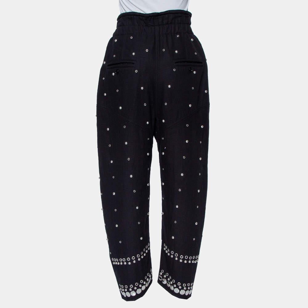 Isabel Marant's Eloma pants made using cotton feature a smocked waist, zip closure, four pockets, and embellishment of studs all over. Style guide: Team it with a fitted top, a belt, and open-toe heels.

Includes: Brand Tag