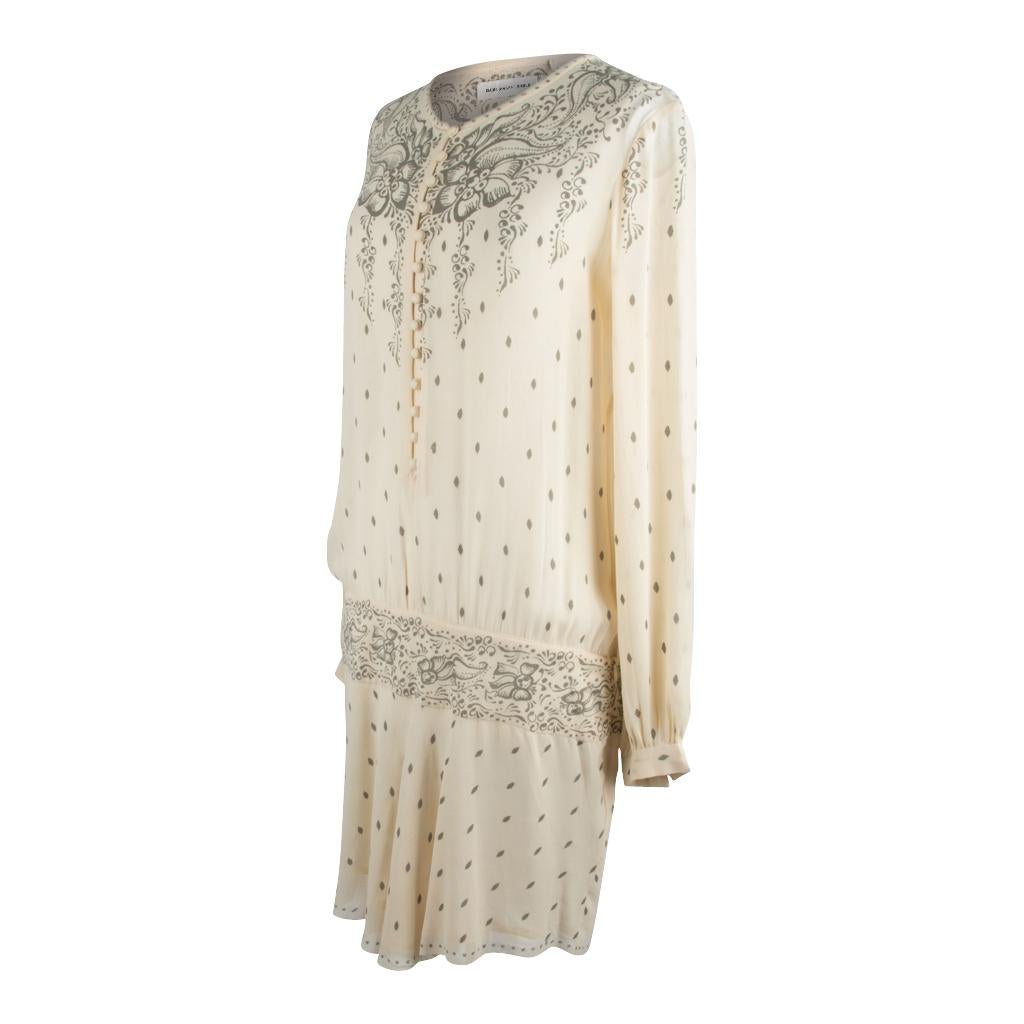 Guaranteed authentic Isabel Marant Etoile creme and gray print dress.
Whimsical gray flowers and flourishes on a creme background.
Drop waist band with floral gray print. 
13 covered buttons in front.
Long sleeves with 1 button on each cuff.  
Dress