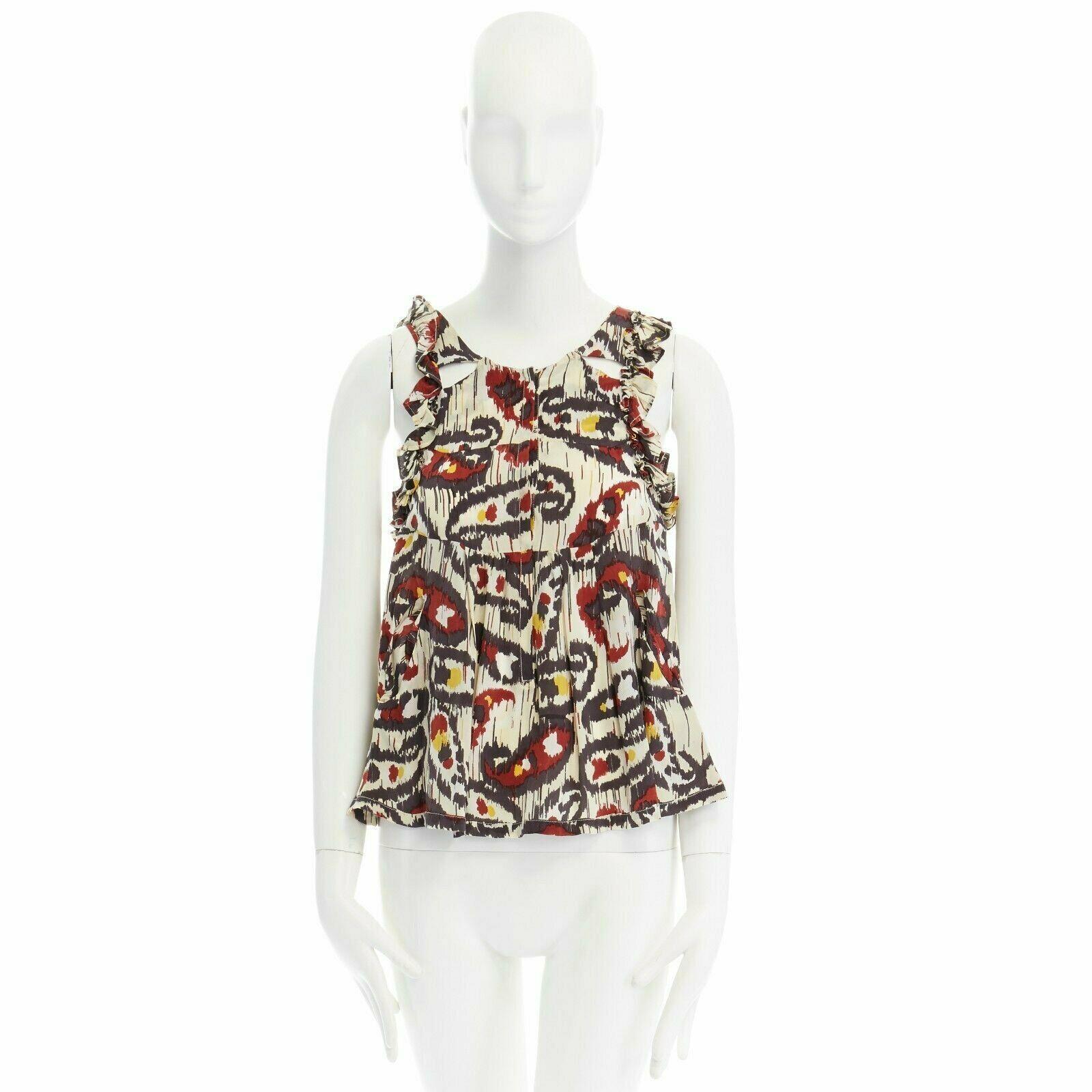 ISABEL MARANT Ikat cream ethnic print silk ruffle cut-out top FR34 XS US2 UK6 
Reference: TGAS/A00034 
Brand: Isabel Marant 
Designer: Isabel Marant 
Material: Silk 
Color: White 
Pattern: Other 
Closure: Hook & Eye 
Extra Detail: White with ethnic