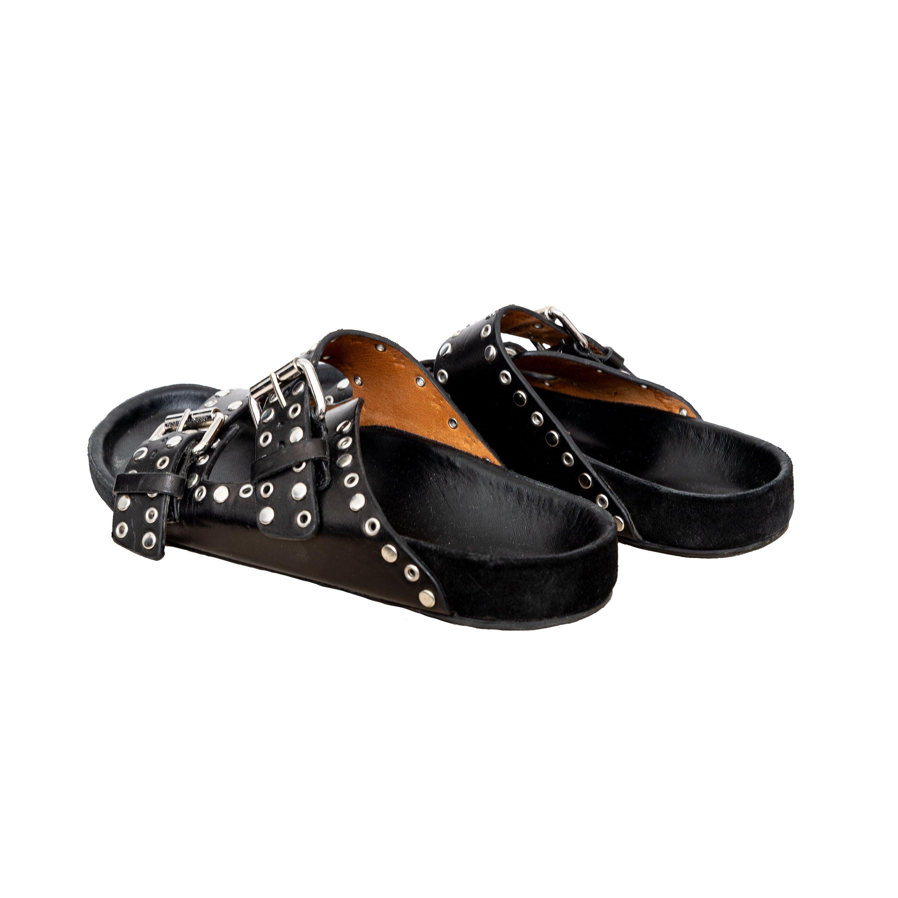 These black leather sandals from Isabel Marant feature studded silver accents, round open toes, two adjustable buckle straps and flat heels for comfort. 
 Measurement: Insole Length:23;Heel:2 
 Material: Leather