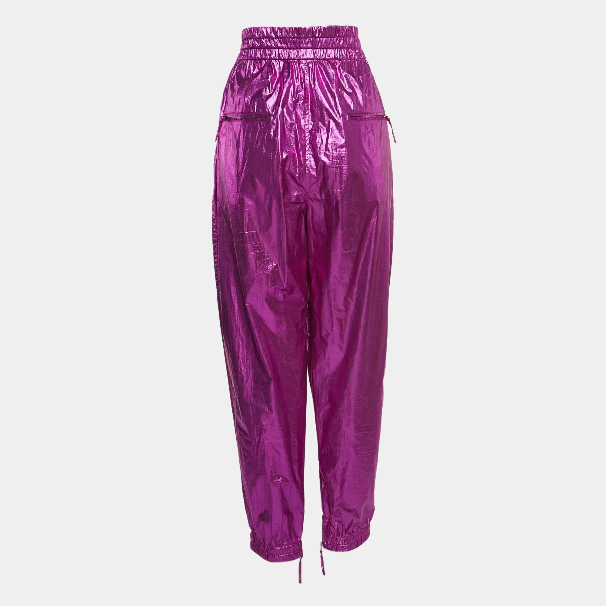 The Isabel Marant trousers blend contemporary style with comfort. Crafted from high-quality cotton, these trousers feature a metallic pink hue, a flattering carrot-fit silhouette, and Galoni detailing, making them a chic and versatile choice for