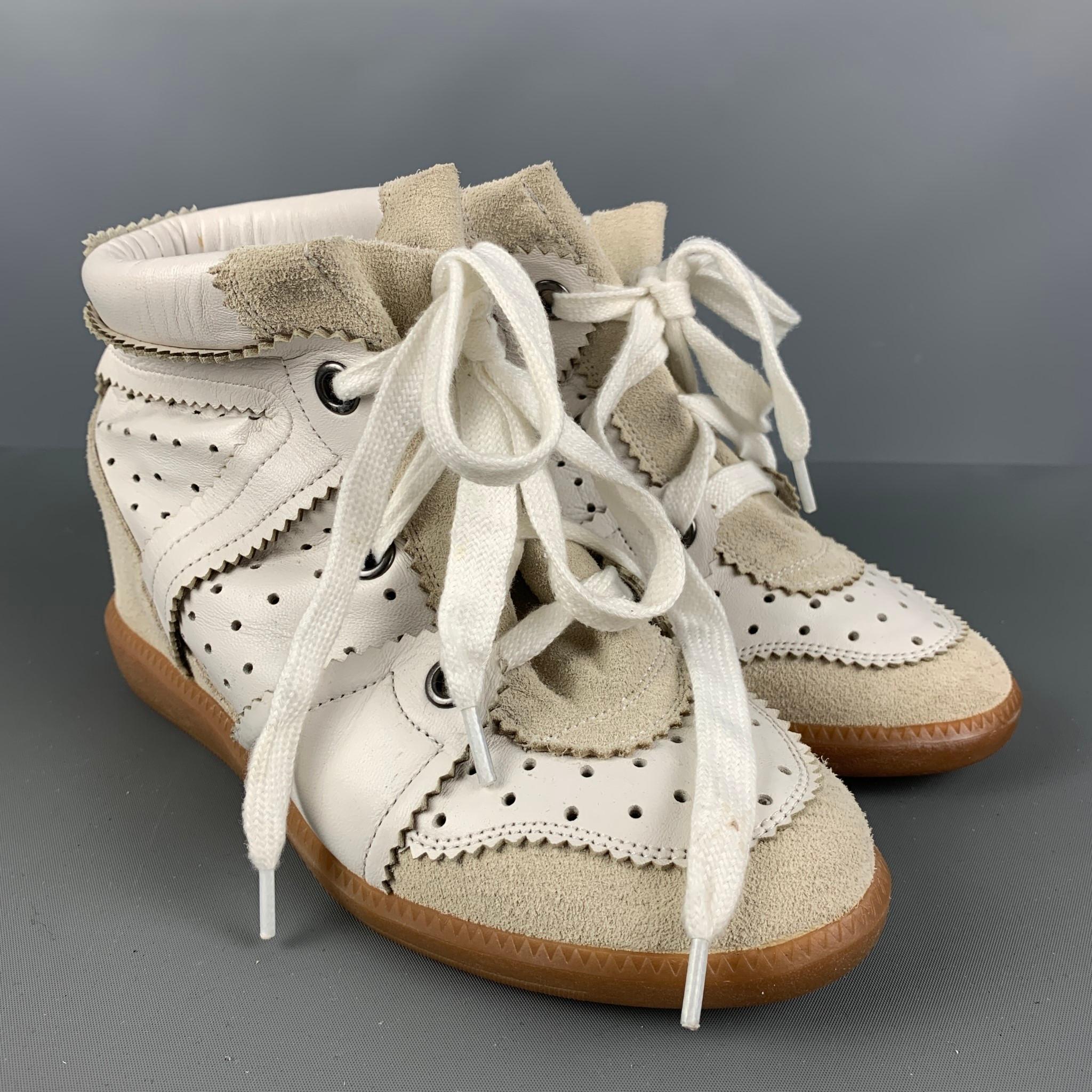 ISABEL MARANT sneakers comes in a white & beige perforated leather featuring a wedge style,rubber sole, and a lace up closure.

Very Good Pre-Owned Condition.
Marked: 37

Outsole: 9.5 in. x 3.5 in.  

SKU: 124362
Category: Sneakers

More