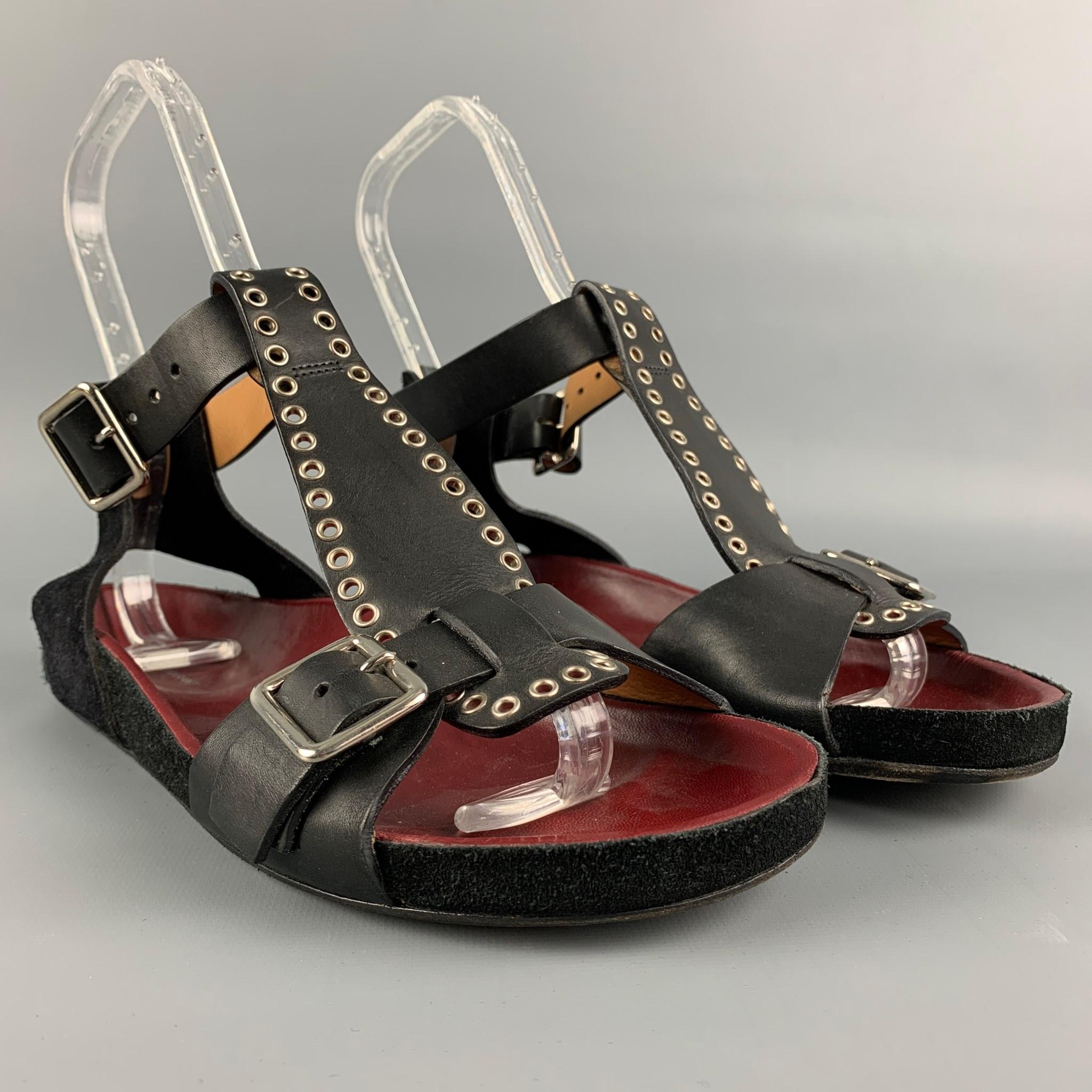 ISABEL MARANT flats comes in a black & silver featuring a t-strap, grommet details, and a strap buckle closure. Made in Italy.

Good Pre-Owned Condition.
Marked: 38

Outsole: 10 in. x 3.5 in. 