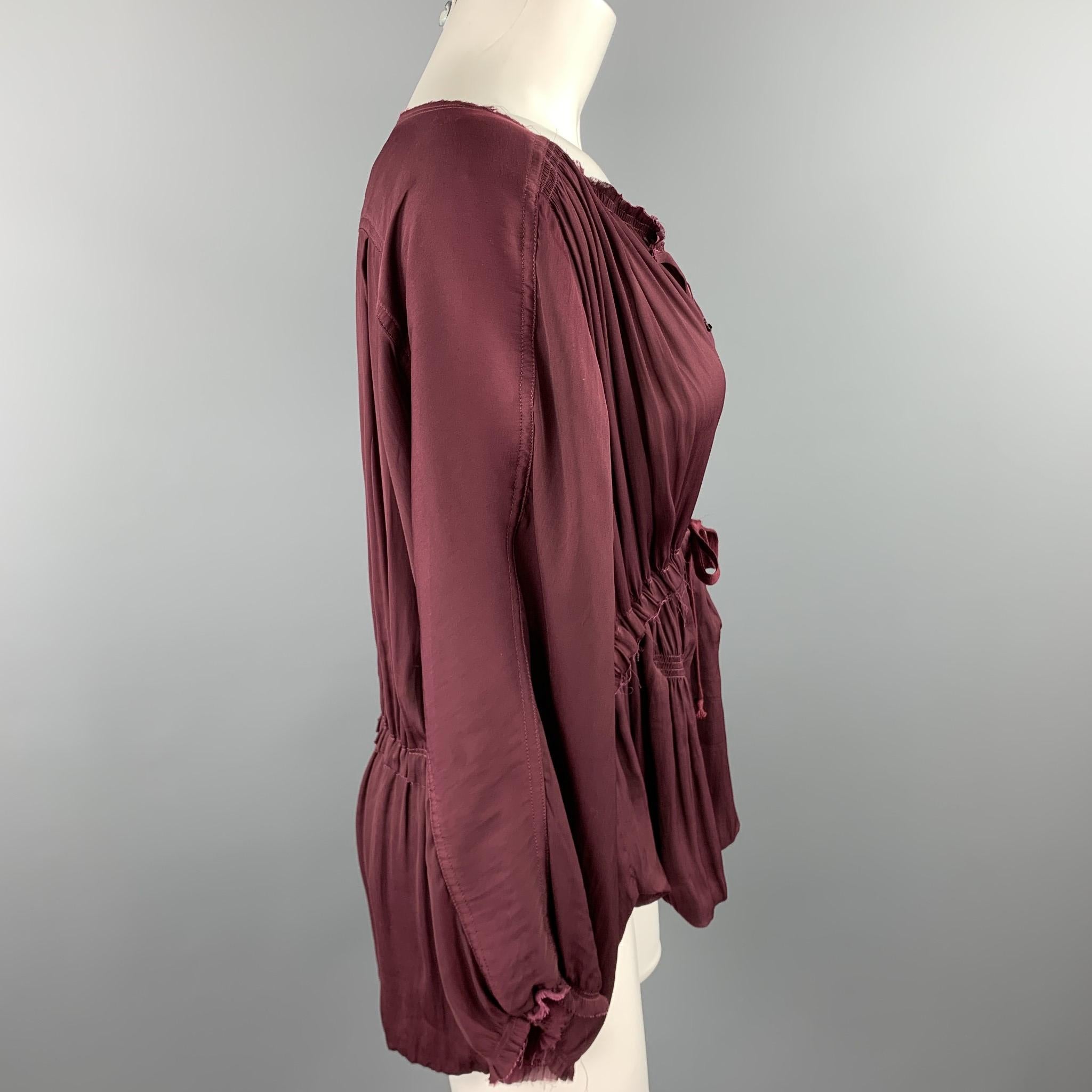 ISABEL MARANT blouse comes in a burgundy polyester featuring a boho style, raw hem, hook & eye detail, and a drawstring closure.

Good Pre-Owned Condition.
Marked: 2

Measurements:

Shoulder: 16 in. 
Bust: 42 in. 
Sleeve: 17.5 in. 
Length: 26 in.