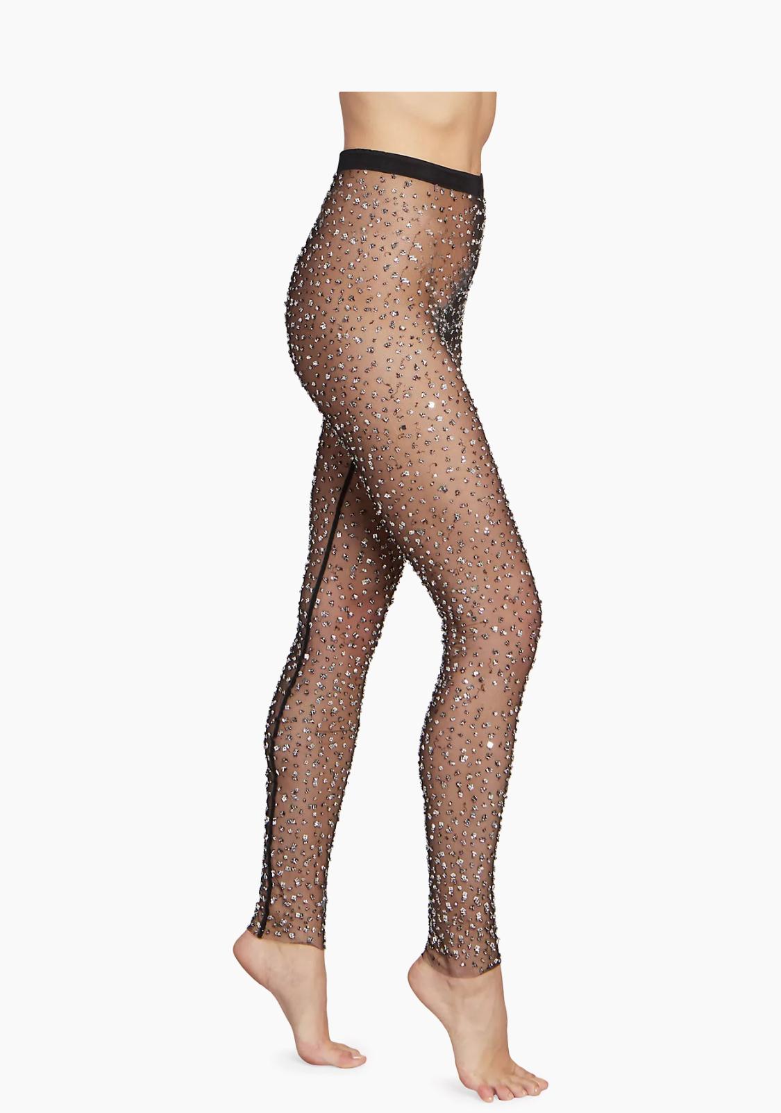 The Isabel Marant Tanael Black Sheer Sequins Leggings are a stunning addition to any fashion-forward wardrobe. These mesh leggings boast an elastic waistband for comfort while exuding glamour with their all-over silver sequin embellishments. They’re