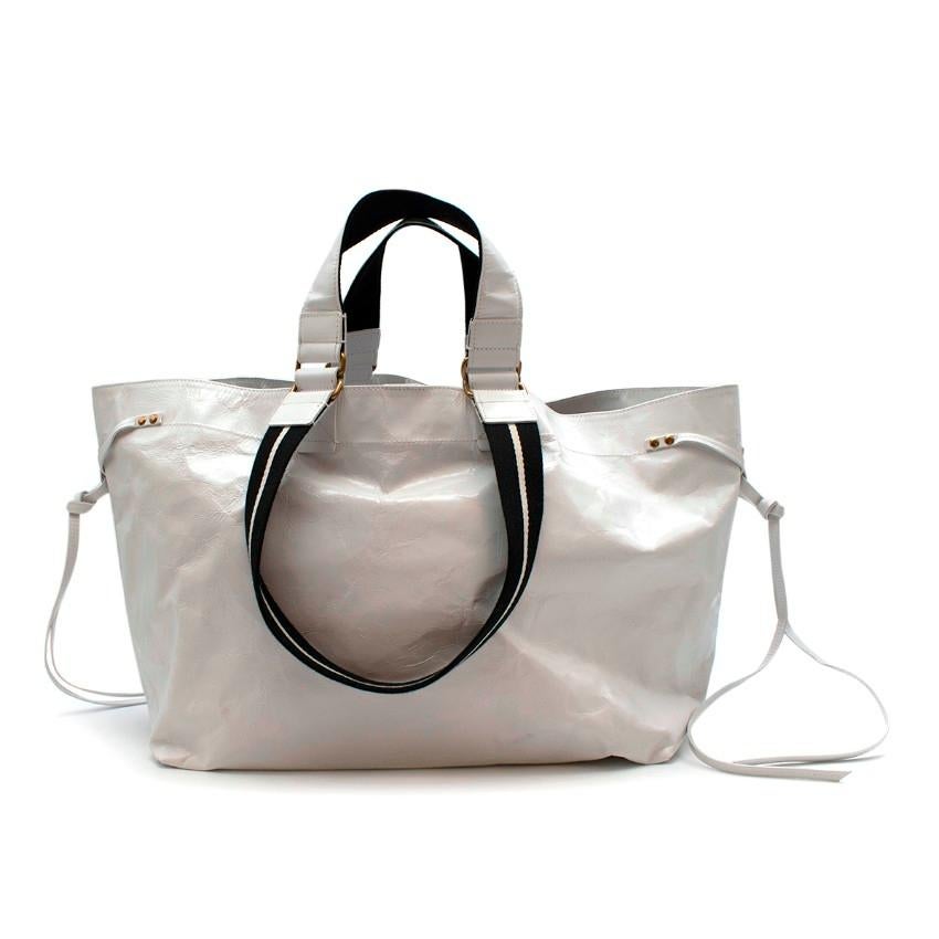 Isabel Marant White 'Wydra' Tote Bag

Double top handles with top magnetic button closure.
One internal zip pocket and fully lined inside.

Materials:
100% Polyvinyl Chloride (PVC)

Measurements:
Length: 55cm
Height: 29cm
Depth: 19cm