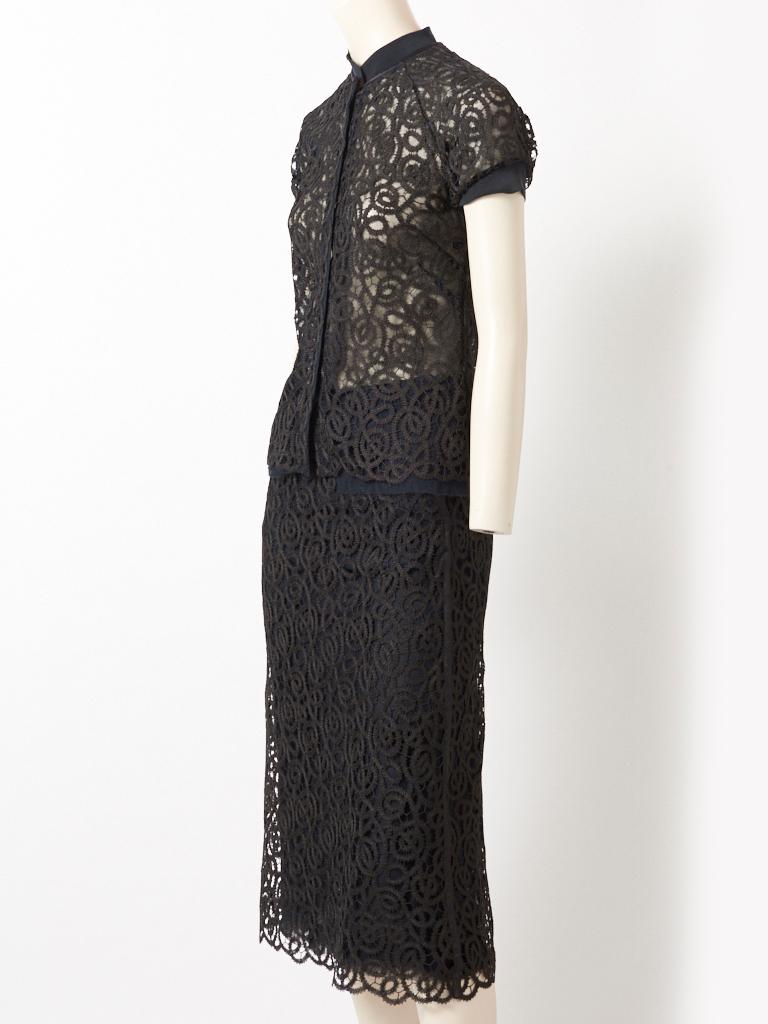 Isabel Toledo, black embroidered lace on tulle 2 piece ensemble. The short sleeve blouse is semi fitted having a hidden front snap closure,  and a Mandarin collar in a stretch jersey ( sleeves are edged in the same jersey ). Black tulle extends