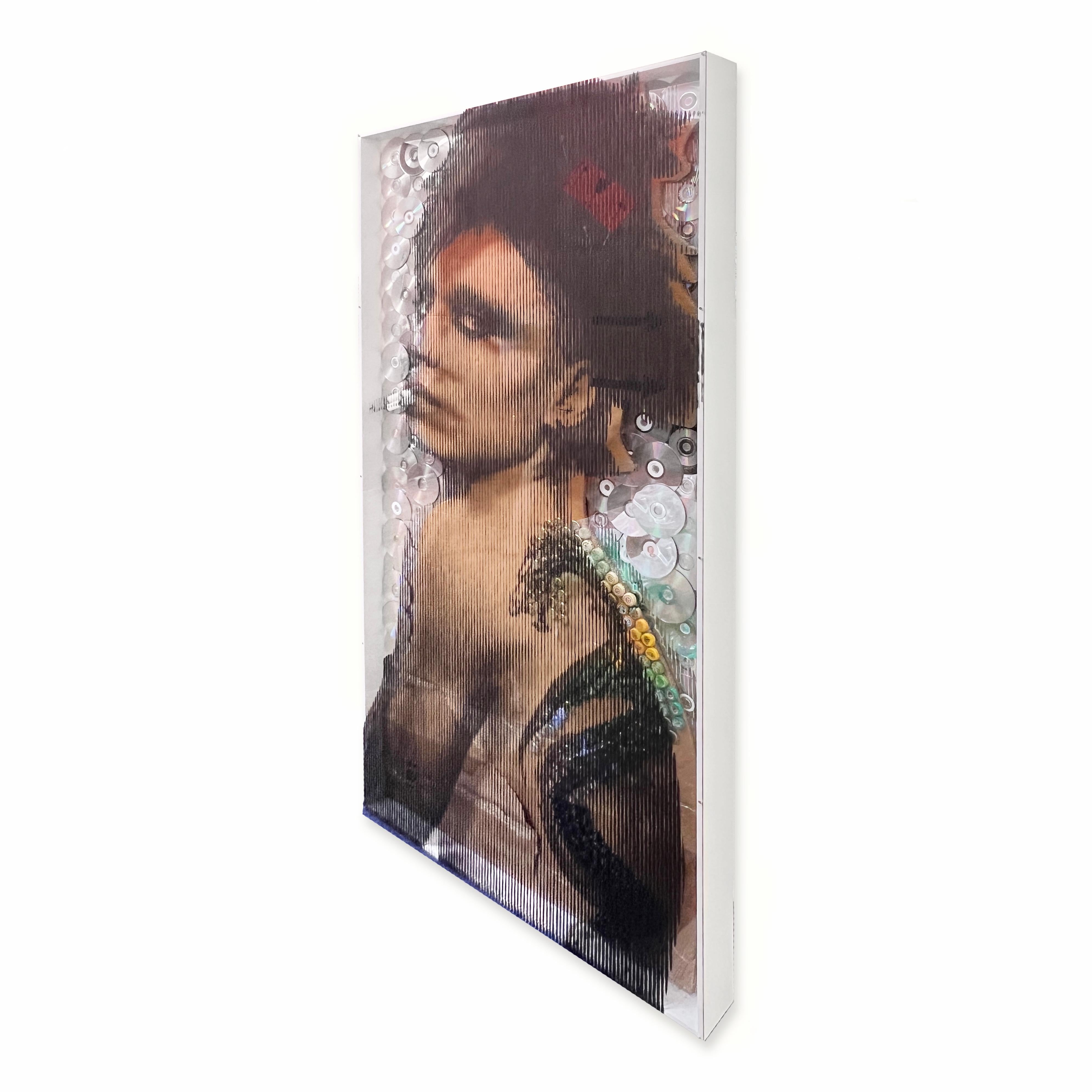 This vertical 79 inch high and 39.5 inch wide and 4 inch deep installation artwork is a one-of-a-kind creation. The half inch white edge of the shadowbox make the frame around the piece, and it contains found and recycled materials such as