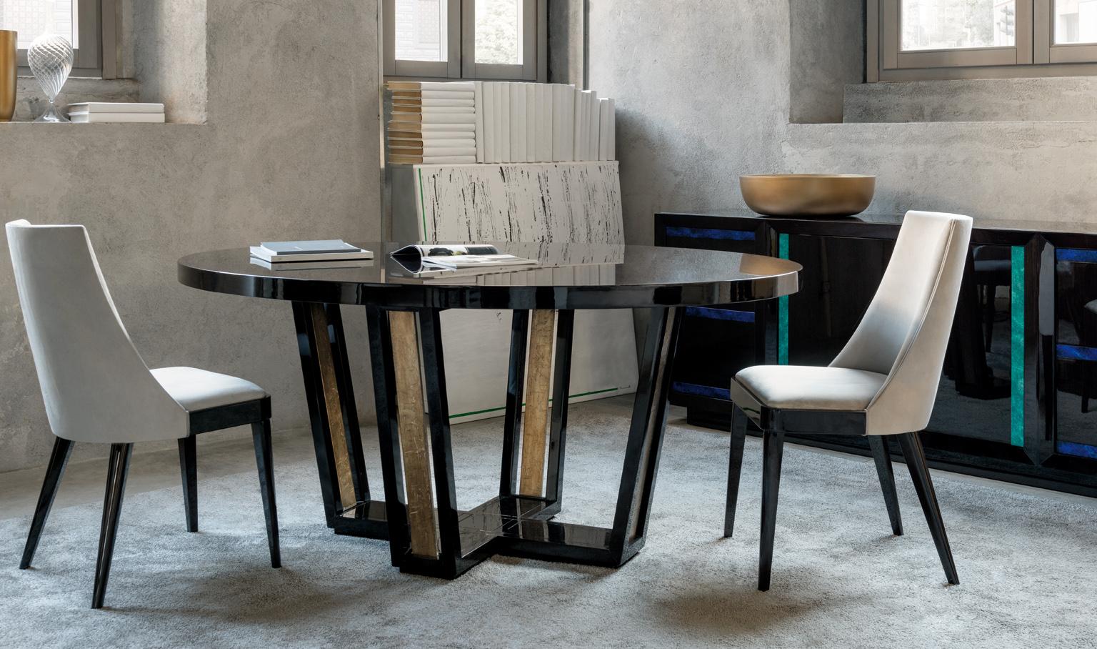Designed by IC, the dining table is symbol of modern design and expert Italian craftsmanship. The luxurious oval dining table with fixed tabletop and base enriched with hand-applied crinkled leaf, offers a glamorous appeal.
Finishes: glossy dark oak