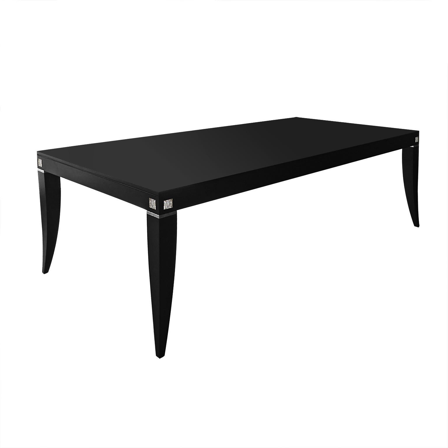 Designed by IC and crafted by expert Italian artisans, the dining table features a rectangular top supported by four curved legs. Its Minimalist look and modern design make it a piece of timeless elegance.
Finish: Matte black lacquered and crinkled