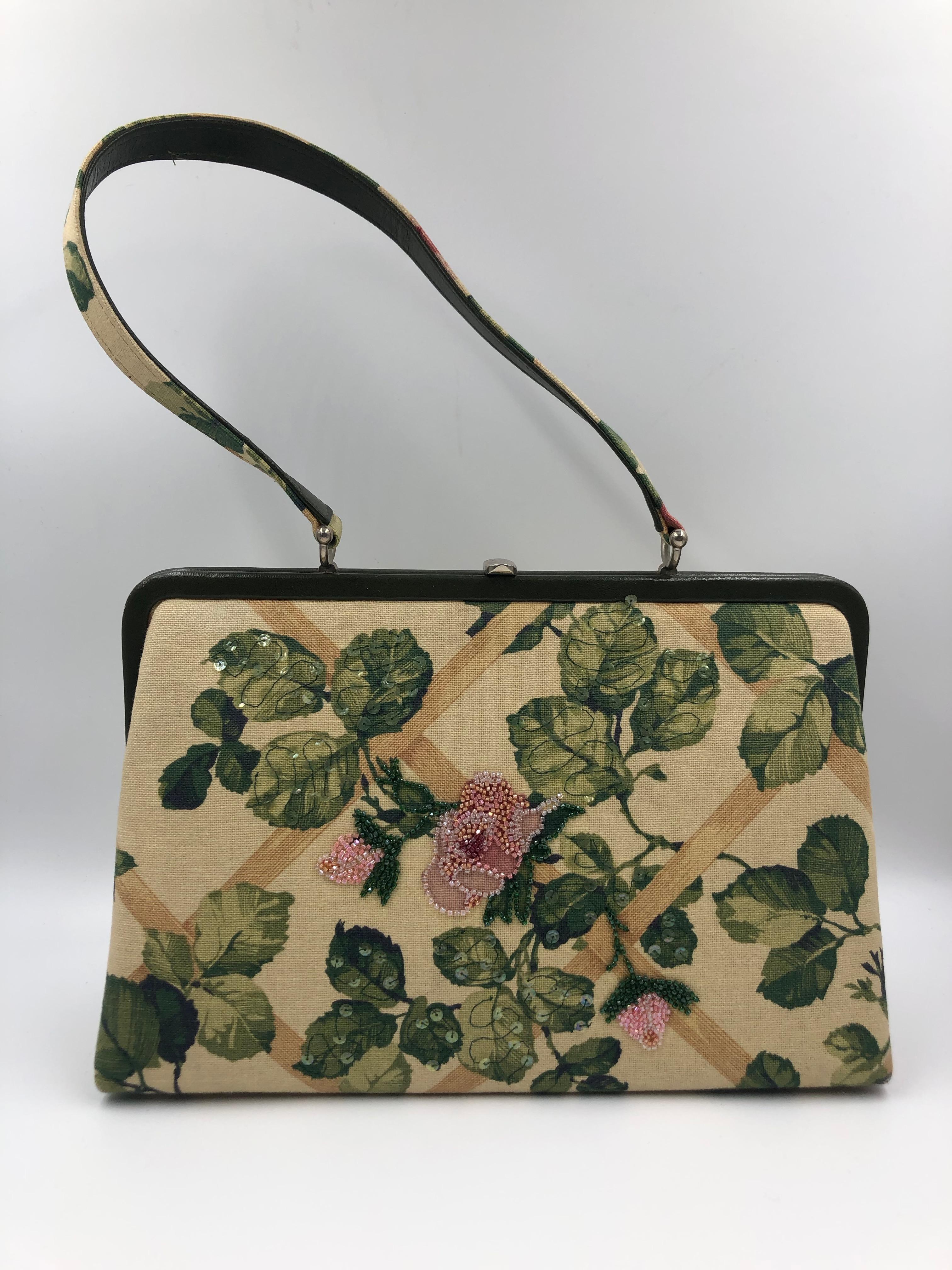 Isabella Fiore Floral Fabric Handbag with leaf sequined design and beaded pink flower in the middle. On front of the bag only. Inside of bag is green fabric lining. Top snap closure. In good vintage condition with slight wear.

Handle - 9