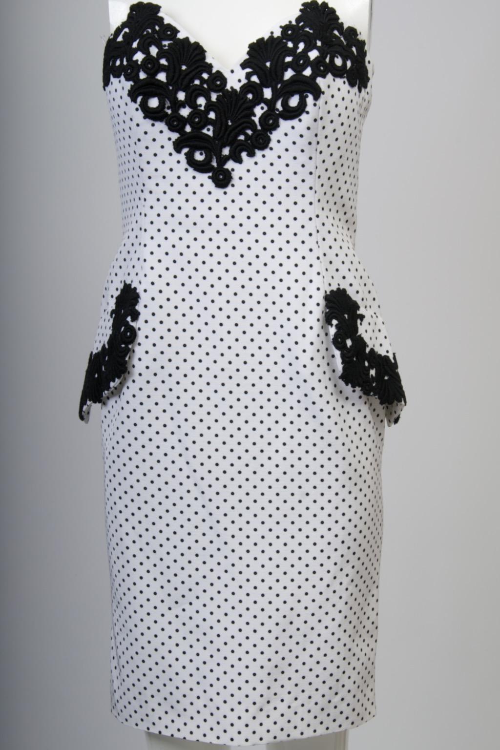 Isabelle Allard 1980s strapless dress and bolero jacket in white faille with tiny black polka dots. The shaped and fitted dress is trimmed at the bustline and faux flap pockets with heavy black lace that punctuates the design. In back, with its