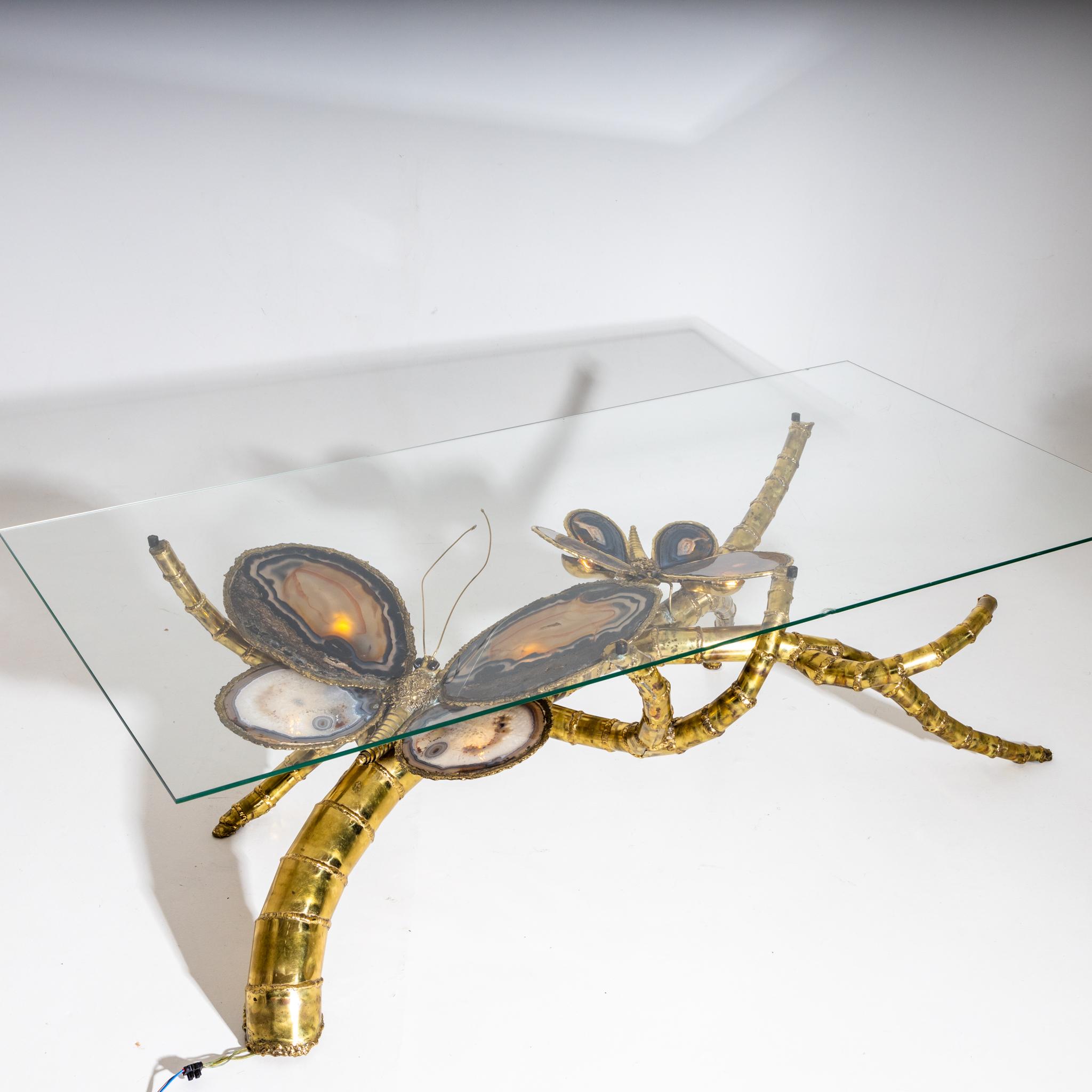 Coffee table out of brass and agate with glass top. The Agate wings are illuminated from below, which makes the butterflies come to live in beautiful colours.