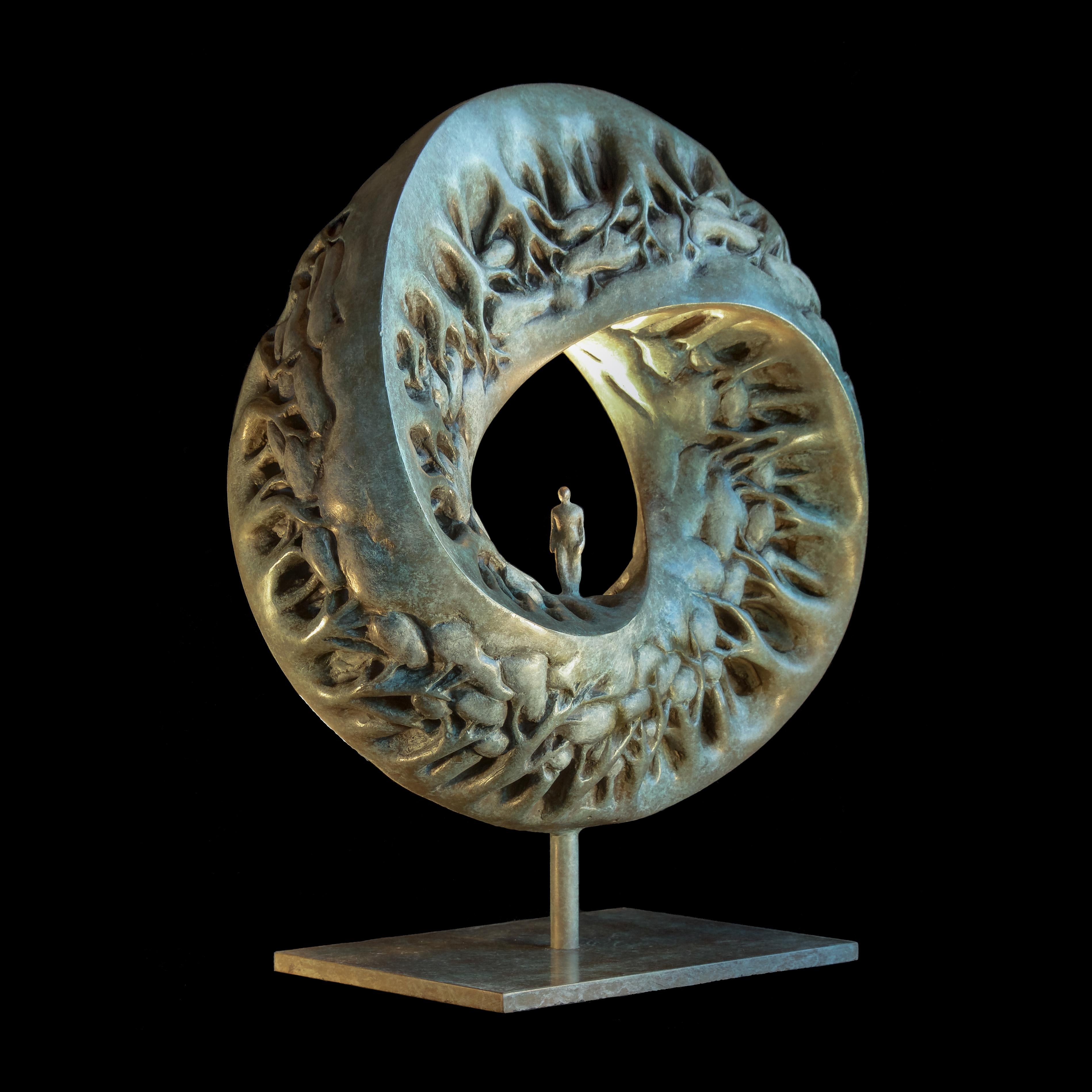 This circular sculpture depicts a small human walking inside a three-sided polygon Möbius band made of trees.

Passionate about the spirit, with her timeless and universal expression in the heart of the human condition, the artist Isabelle Jeandot