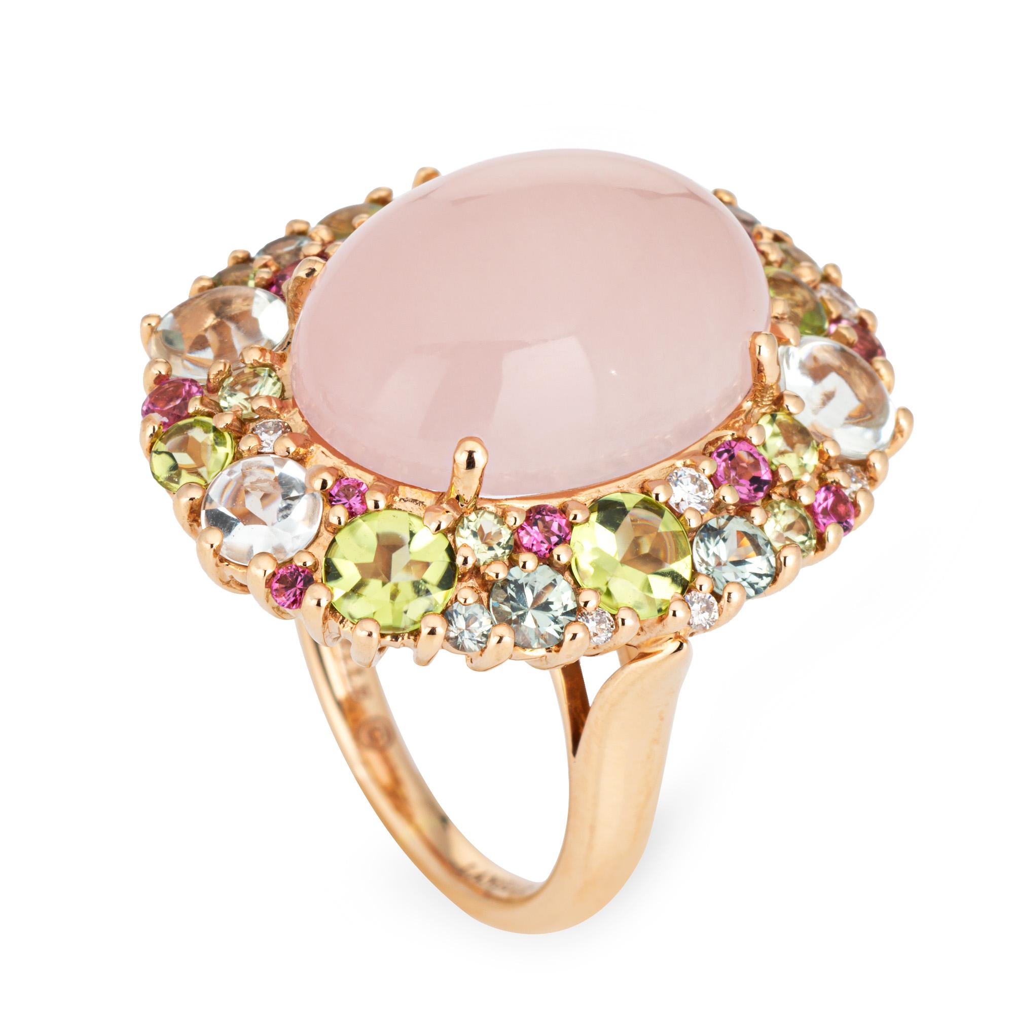 Stylish pre-owned Isabelle Langlois cocktail ring crafted in 18 karat rose gold. 

Center set cabochon cut rose quartz measures 18mm x 13mm. Peridot, pink tourmalines, diamond and blue topaz accent the mount. The stones are in very good condition