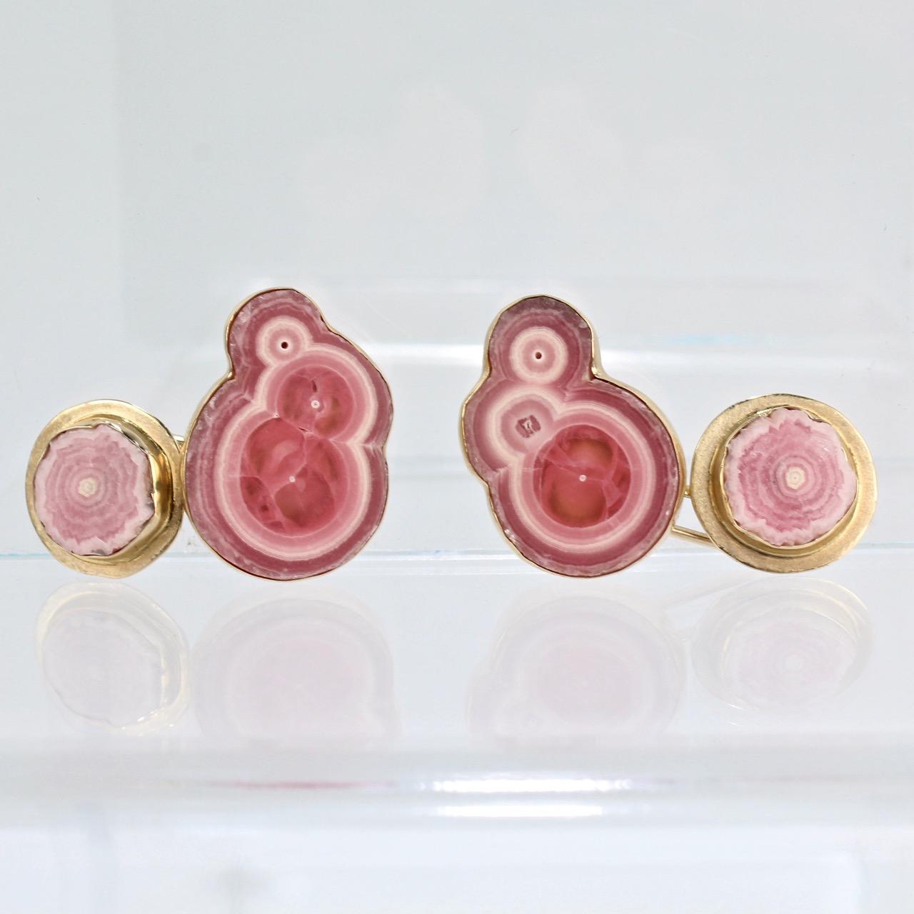 A fine pair of bezel-set 'Rhodochrosite and Gold cufflinks by Isabelle Posillico.

The pink stones in these cufflinks present like banded cross-cuts of fossilized wood with wonderful variation between pinks and whites and are set in 14k and 18K