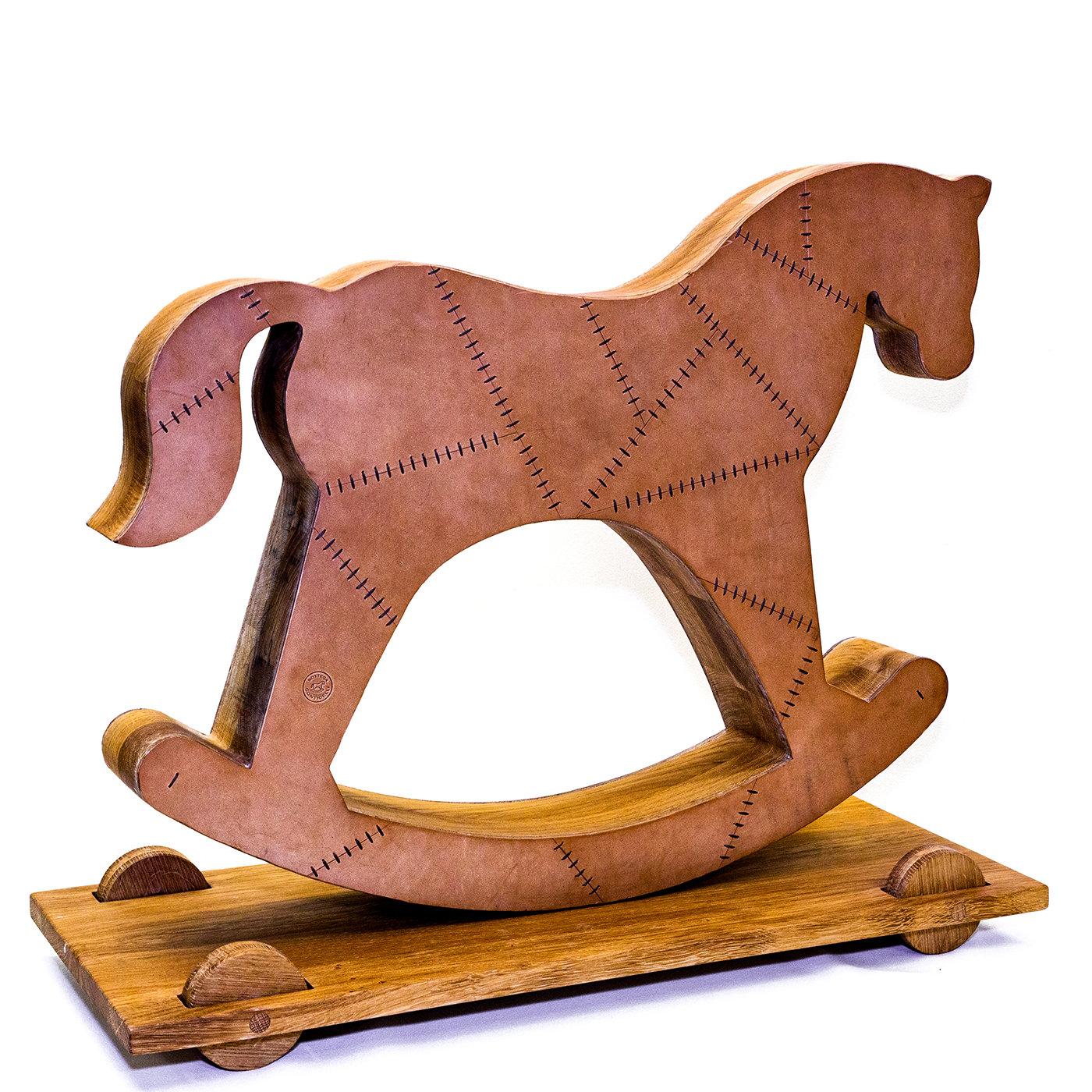 An iconic item distinguishing Bottega Conticelli production, this sculptural rocking horse will become a focal point of any room. Standing on a wooden base, equipped with small wheels, it is hand-crafted of environmentally responsible