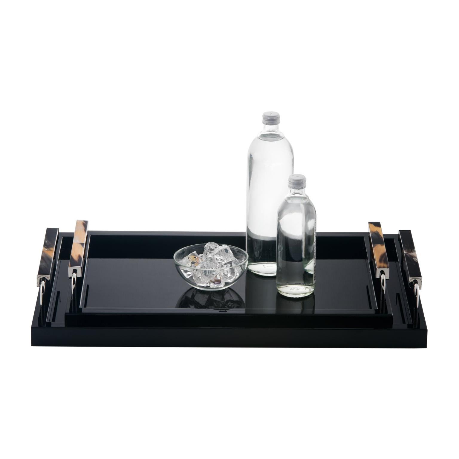 Perfect for serving drinks and hors d'oeuvres or for displaying fine glassware, our Isacco tray features a clean rectangular silhouette crafted of wood, with a high shine black lacquer finish. The design is added an artistic edge by the elegant