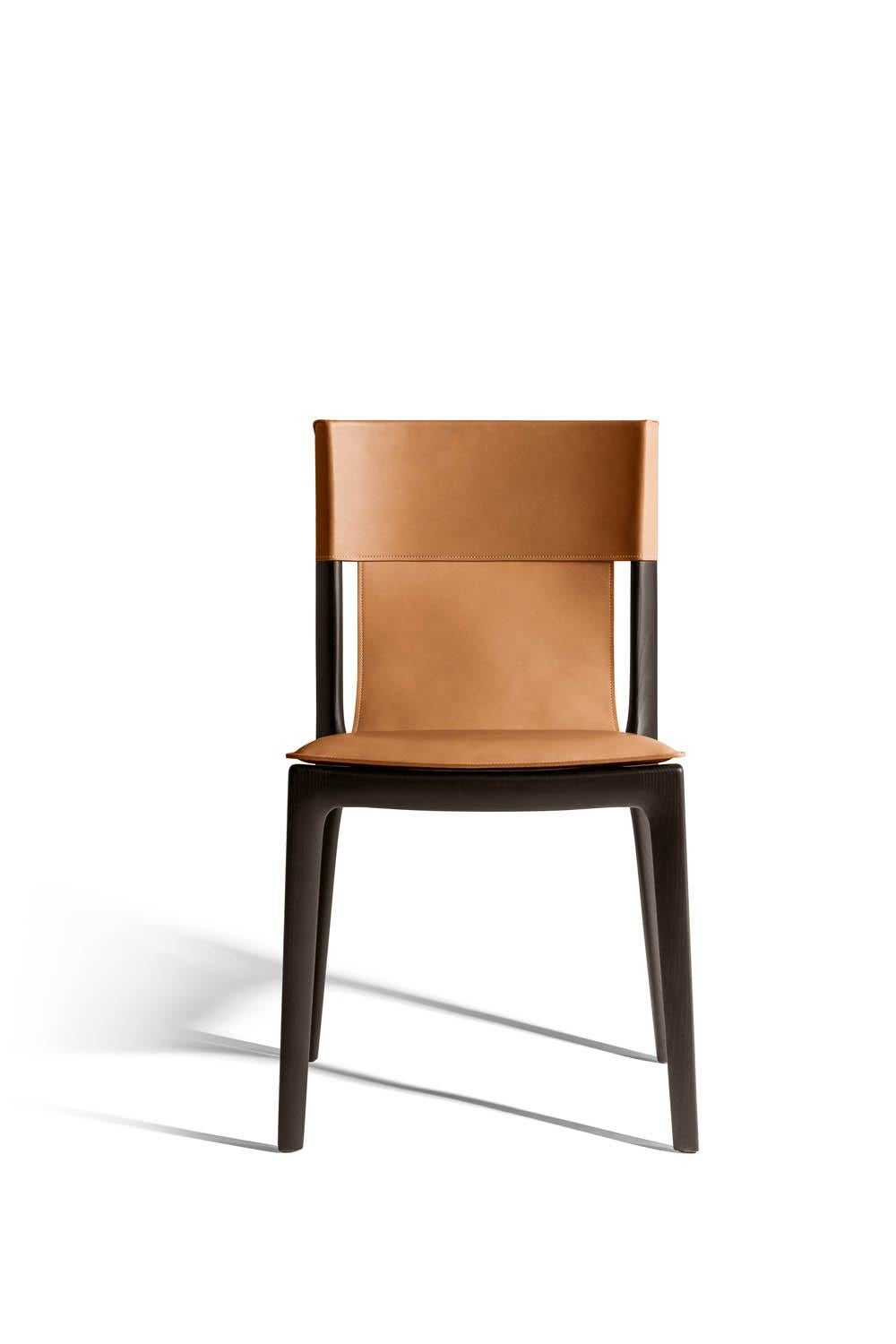 The Isadora chair is inspired by the grace of Isadora Duncan, pioneer of contemporary dance. Created by Roberto Lazzeroni, its original design is shaped by the seamless combination of wood and saddle-leather. The Isadora chair has a solid wood