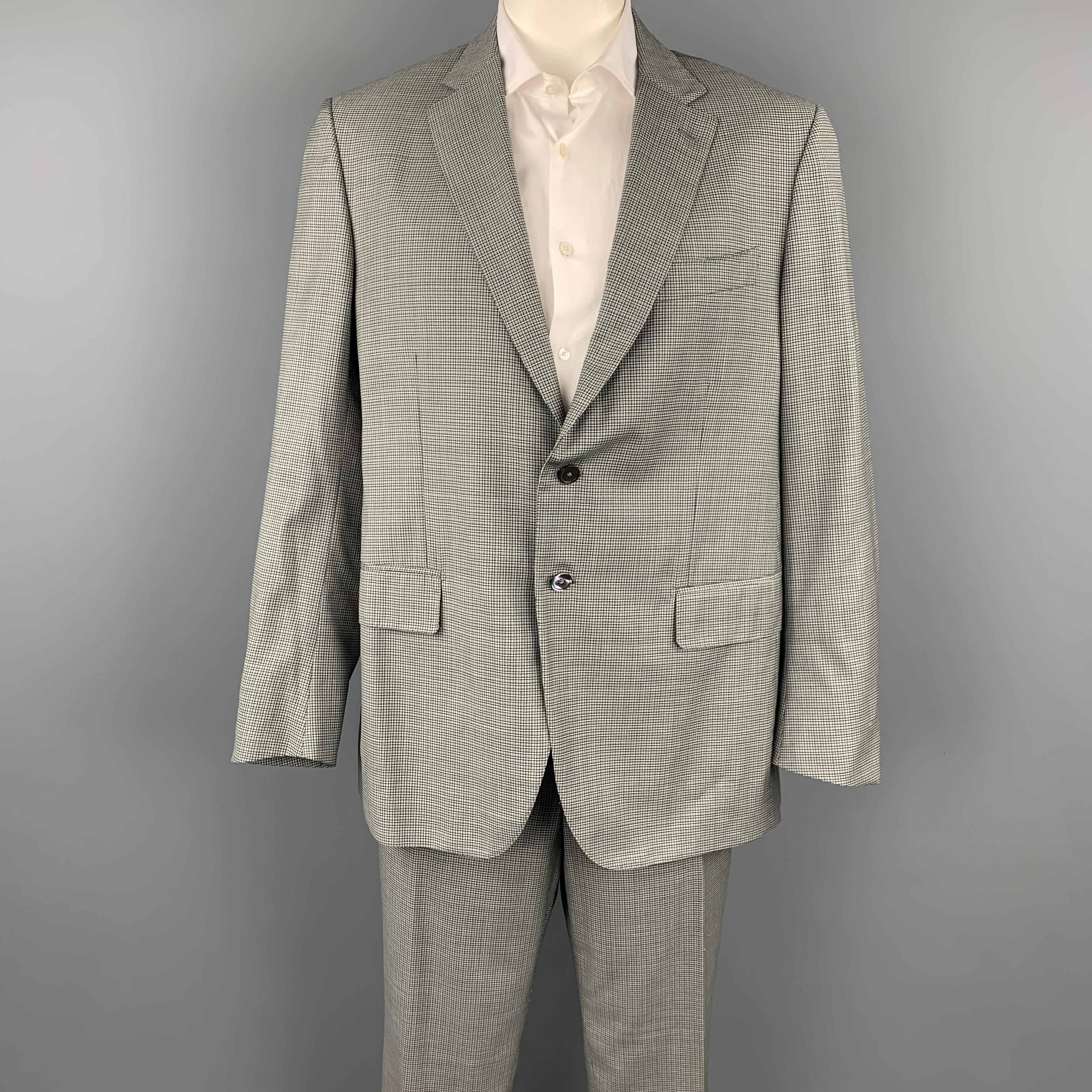 ISAIA suit comes in a light green & brown plaid wool with a full liner and includes a single breasted, two button sport coat with a notch lapel and matching flat front trousers. Made in Italy.

Very Good Pre-Owned Condition.
Marked: 58