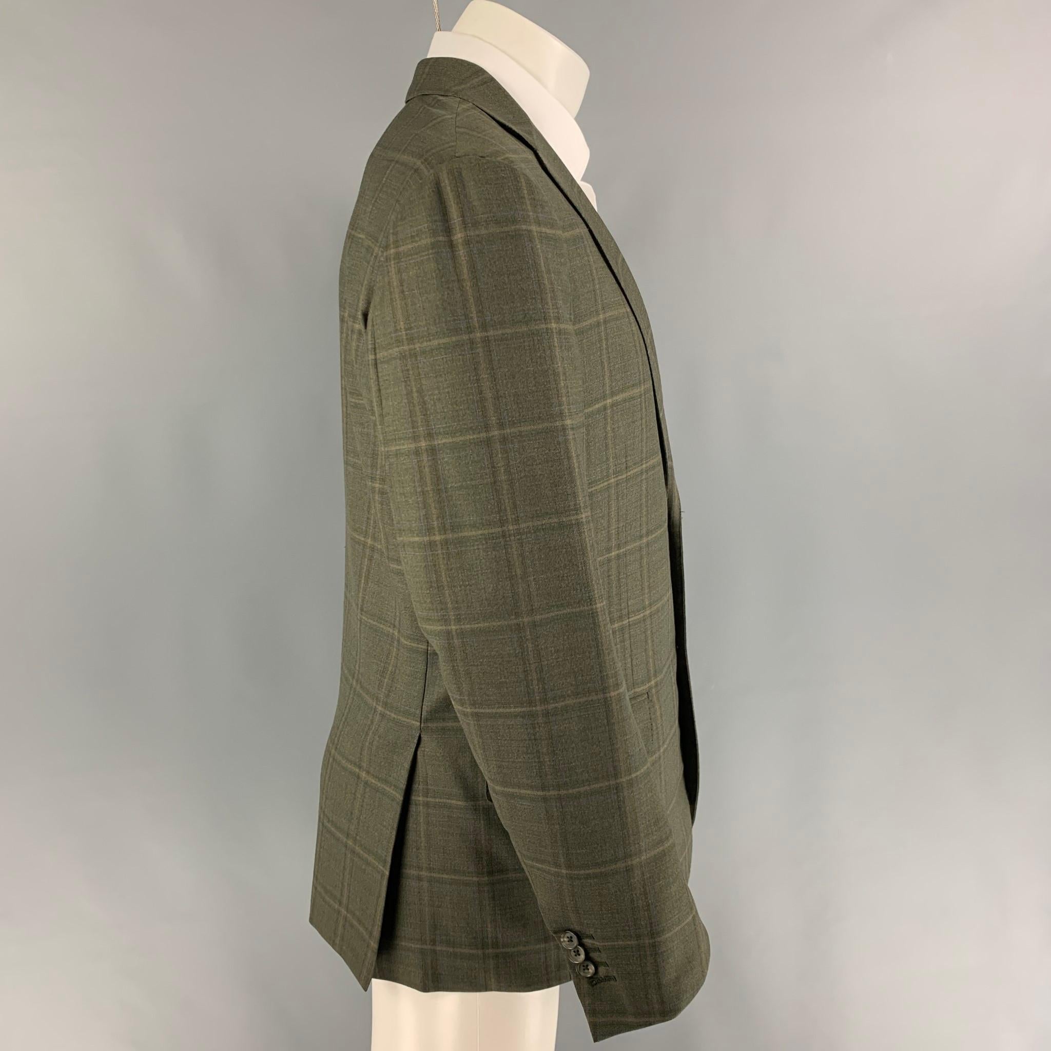ISAIA sport coat comes in a green & yellow plaid wool with a full liner featuring a notch lapel, flap pockets, double back vent, and a double button closure. Made in Italy.
 
Very Good Pre-Owned Condition.
Marked: 50

Measurements:

Shoulder: 18.5