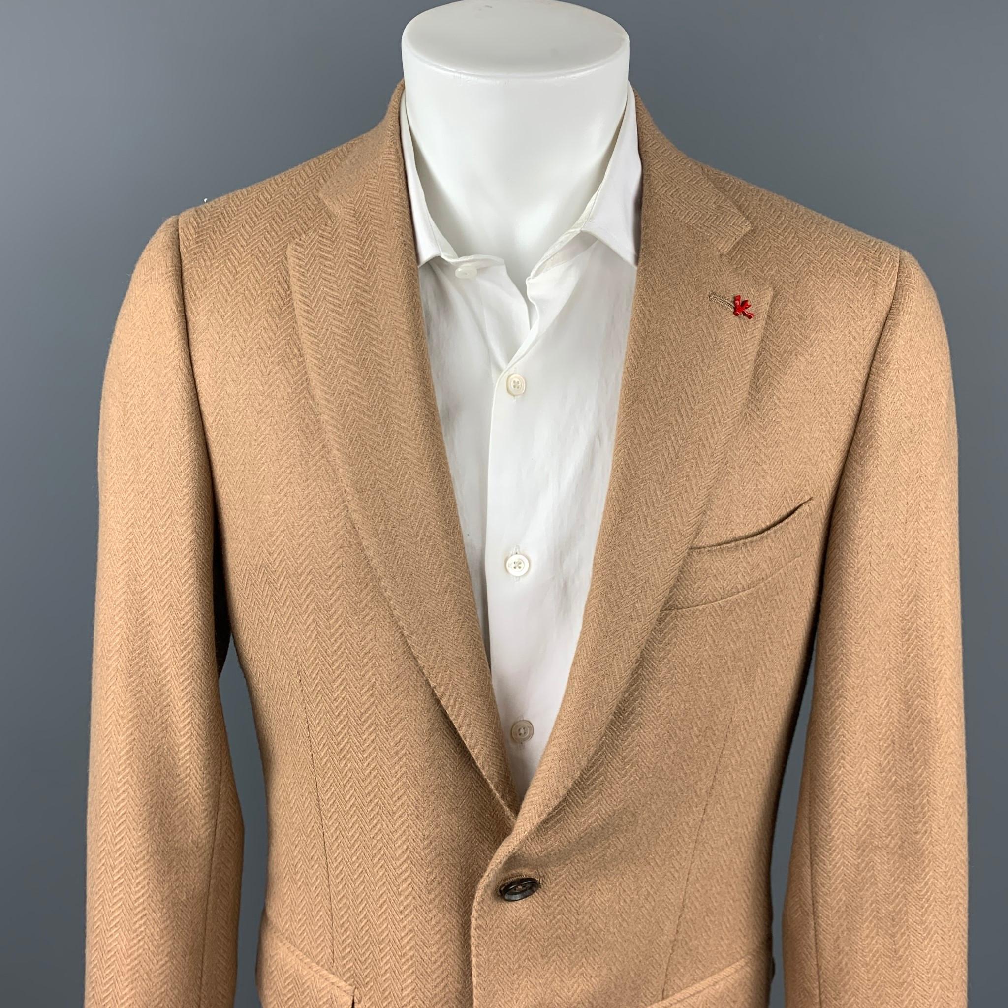 ISAIA sport coat comes in a camel herringbone camel hair with a full liner featuring a notch lapel, flap pockets, and a two button closure. Made in Italy.

Very Good Pre-Owned Condition.
Marked: 50

Measurements:

Shoulder: 17 in.
Chest: 40