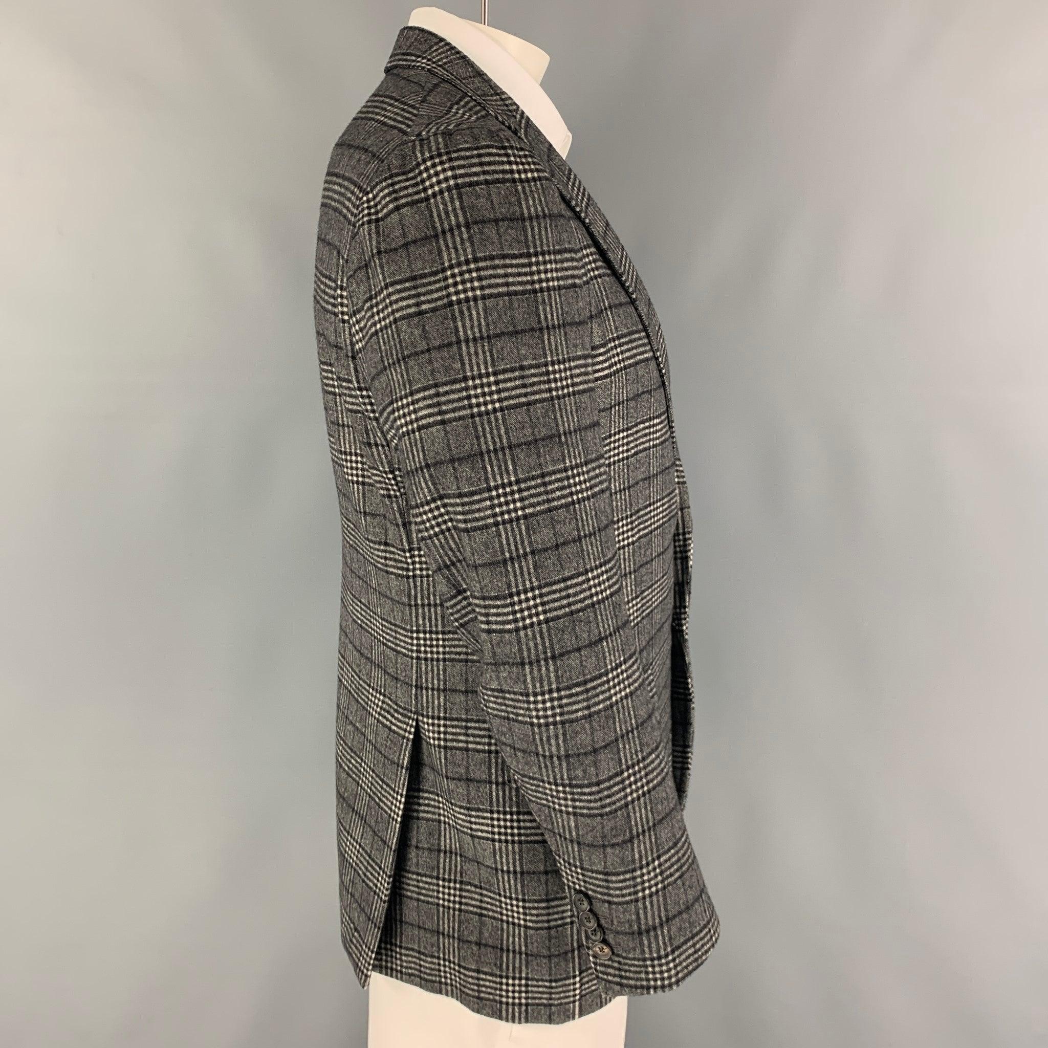ISAIA sport coat comes in a black & white plaid wool with a half liner featuring a notch lapel, flap pockets, double back vent, and a double button closure.
Excellent
Pre-Owned Condition. 

Marked:   52 

Measurements: 
 
Shoulder: 17 inches Chest: