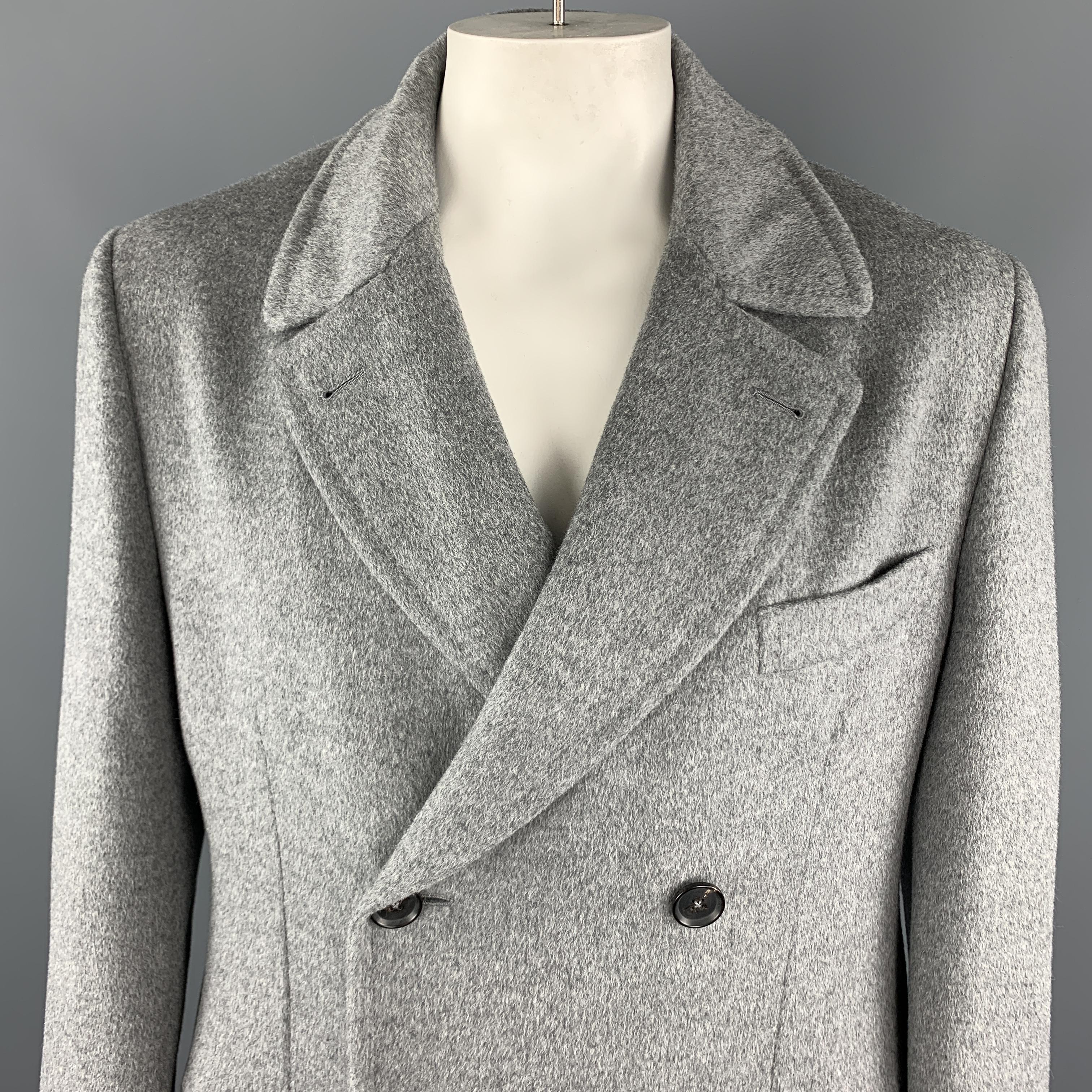 ISAIA Long Peacoat comes in a gray solid angora / wool material, double breasted, with slit and flap pockets, unbuttoned cuffs, belted back and a single vent at back. Made in Italy.

Excellent Pre-Owned Condition.
Marked: IT