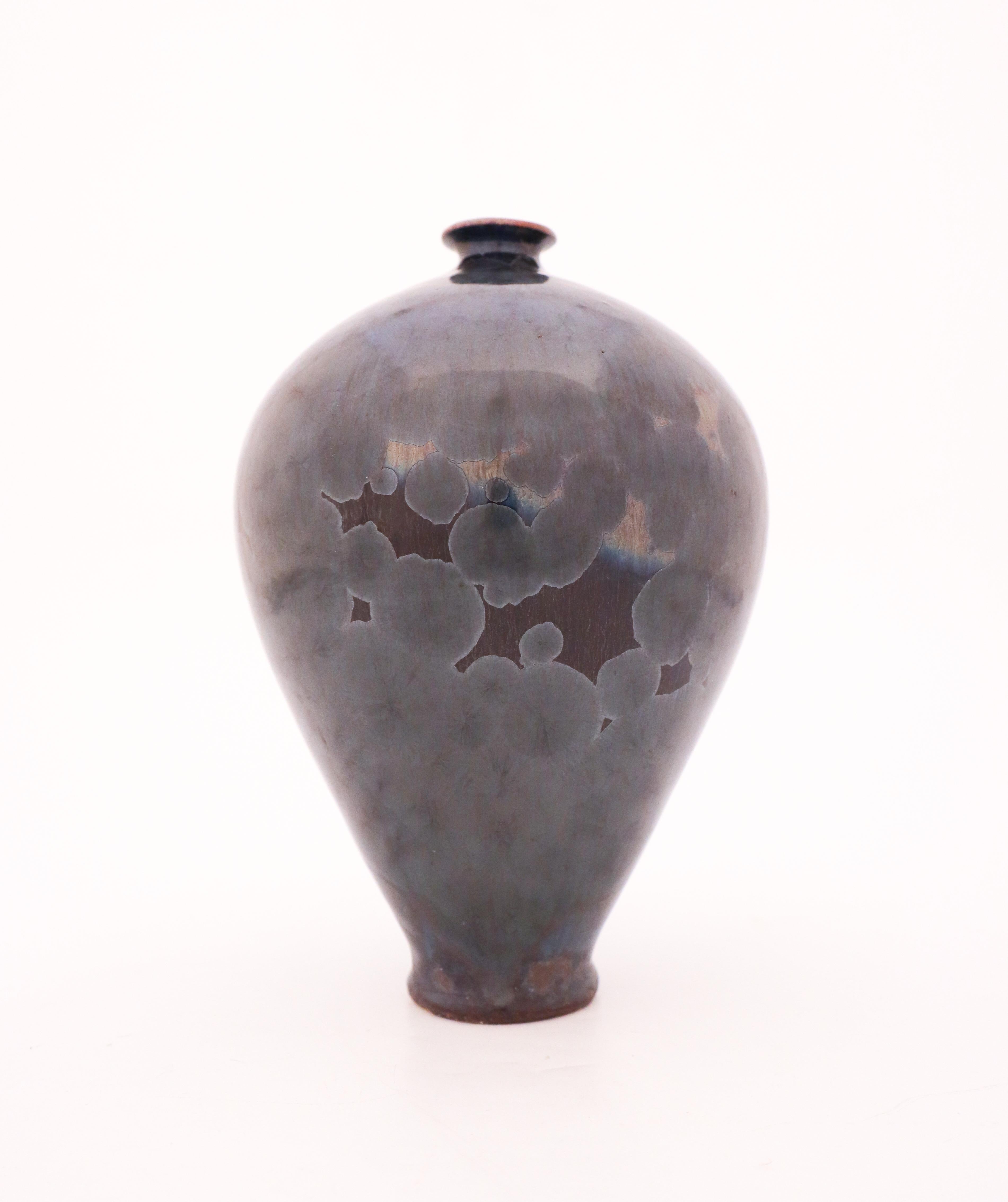 A unique vase in a black with a metallic-tone of crystalline glaze designed by the contemporary Swedish artist Isak Isaksson in his own studio. The vase is 22 cm (8,8