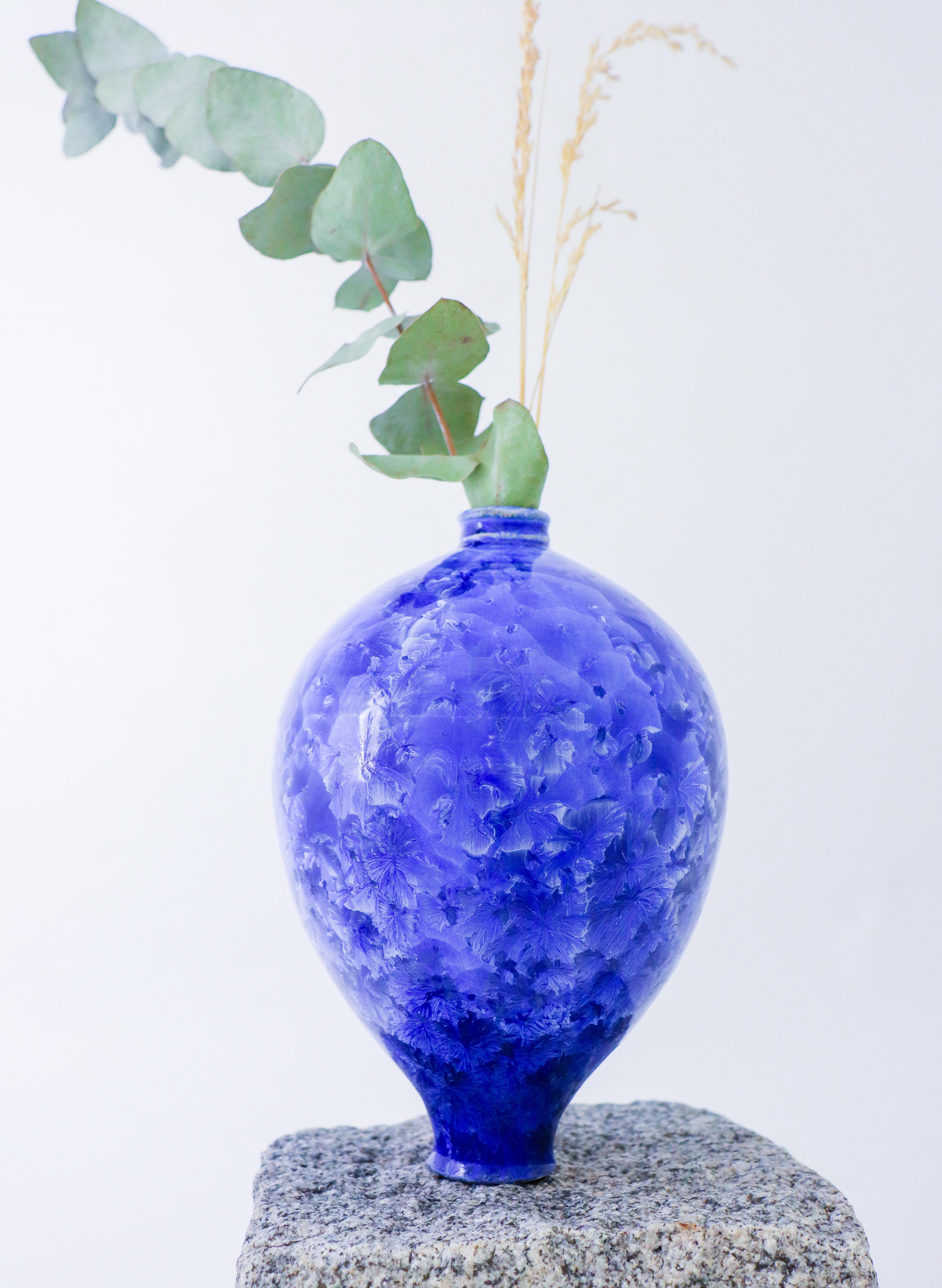This stunning blue ceramic vase, handmade by contemporary artist Isak Isaksson, is a true work of art. With a height of 21 cm and a glossy finish, this piece features an abstract pattern that is sure to catch the eye. The vase is signed by the