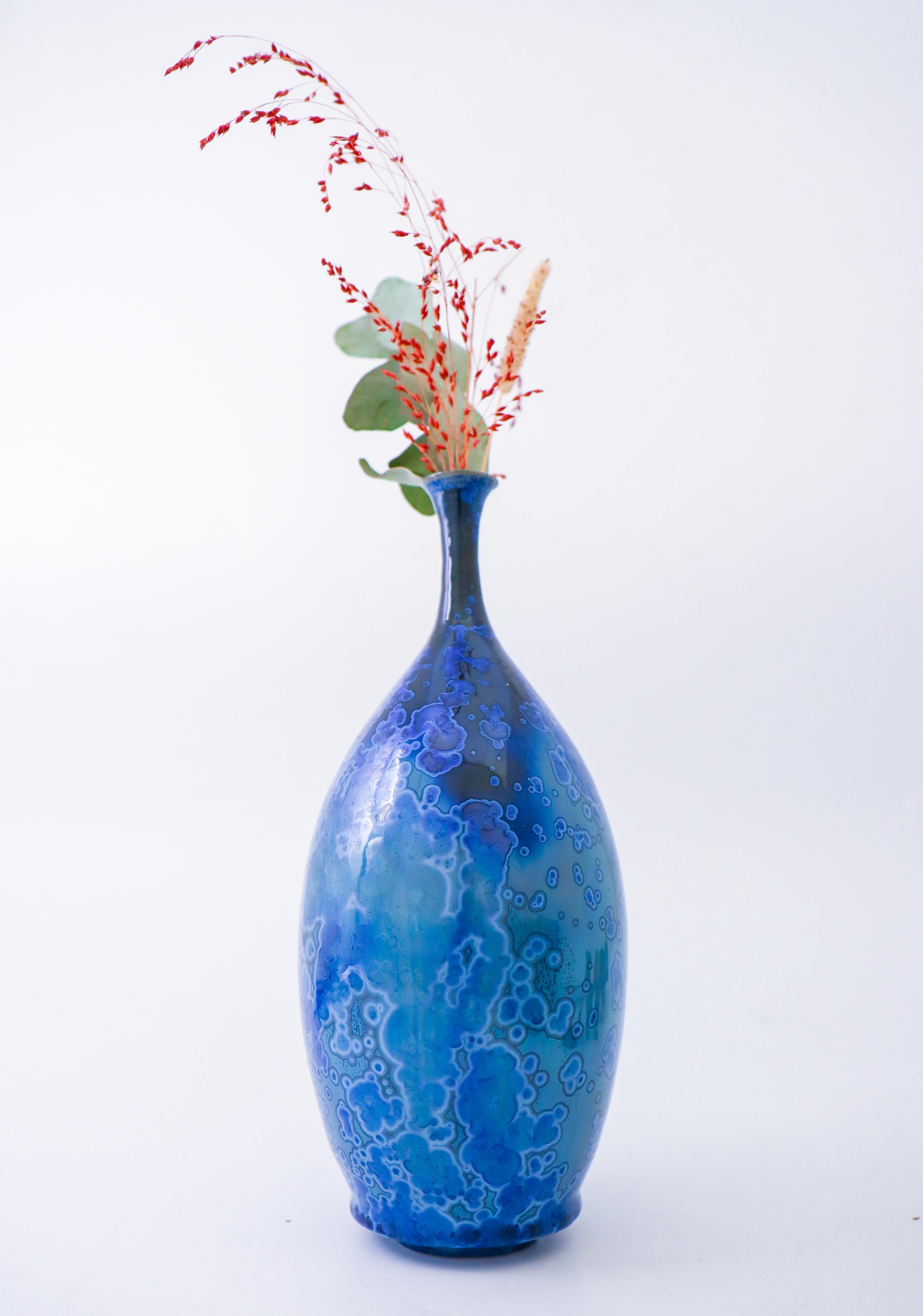A blue vase with a lovely crystalline glaze designed by Isak Isaksson in Sweden. The vase is 25 cm (10