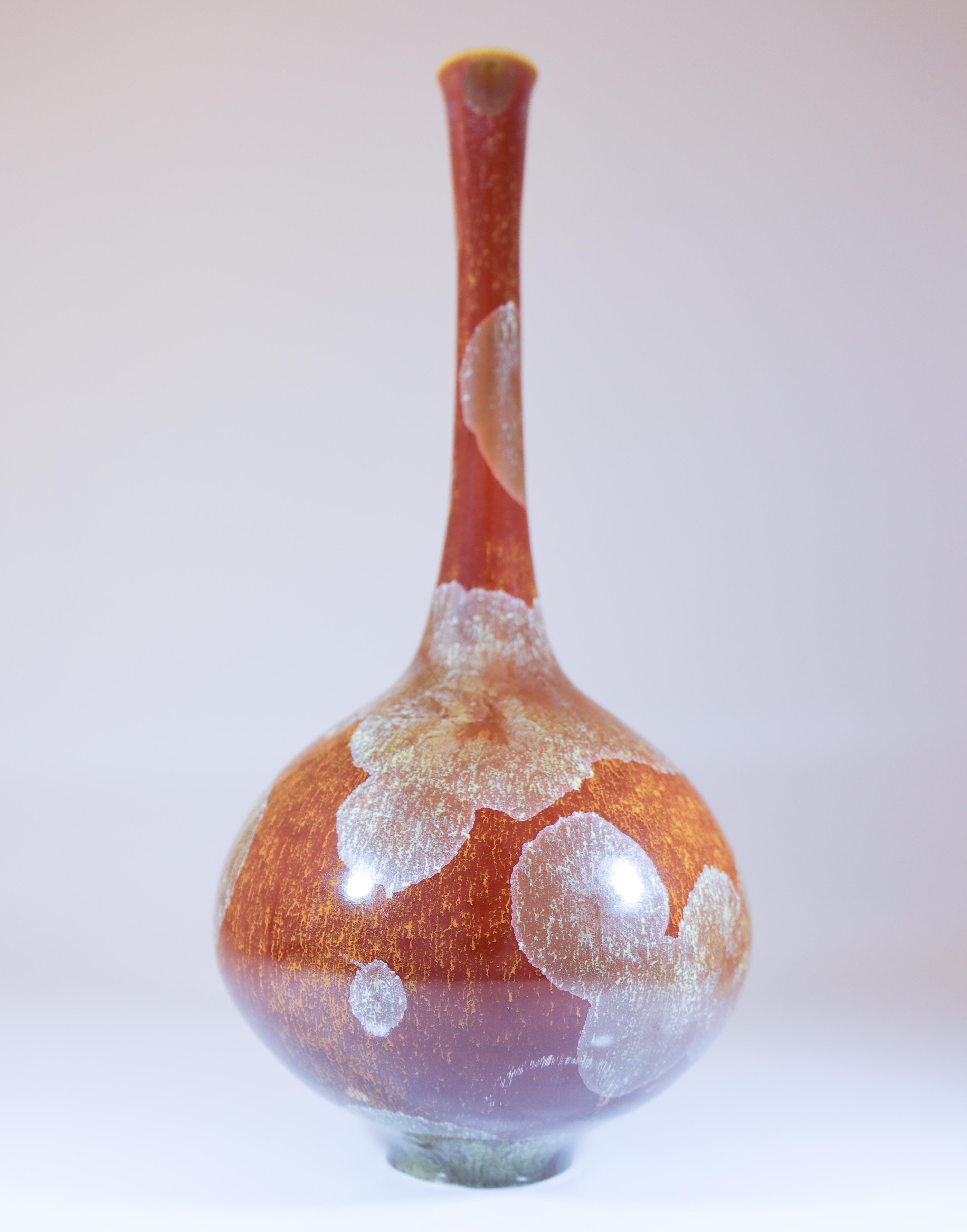 A brown vase with a lovely crystalline glaze designed by Isak Isaksson in Sweden. The vase is 27 cm (10.8