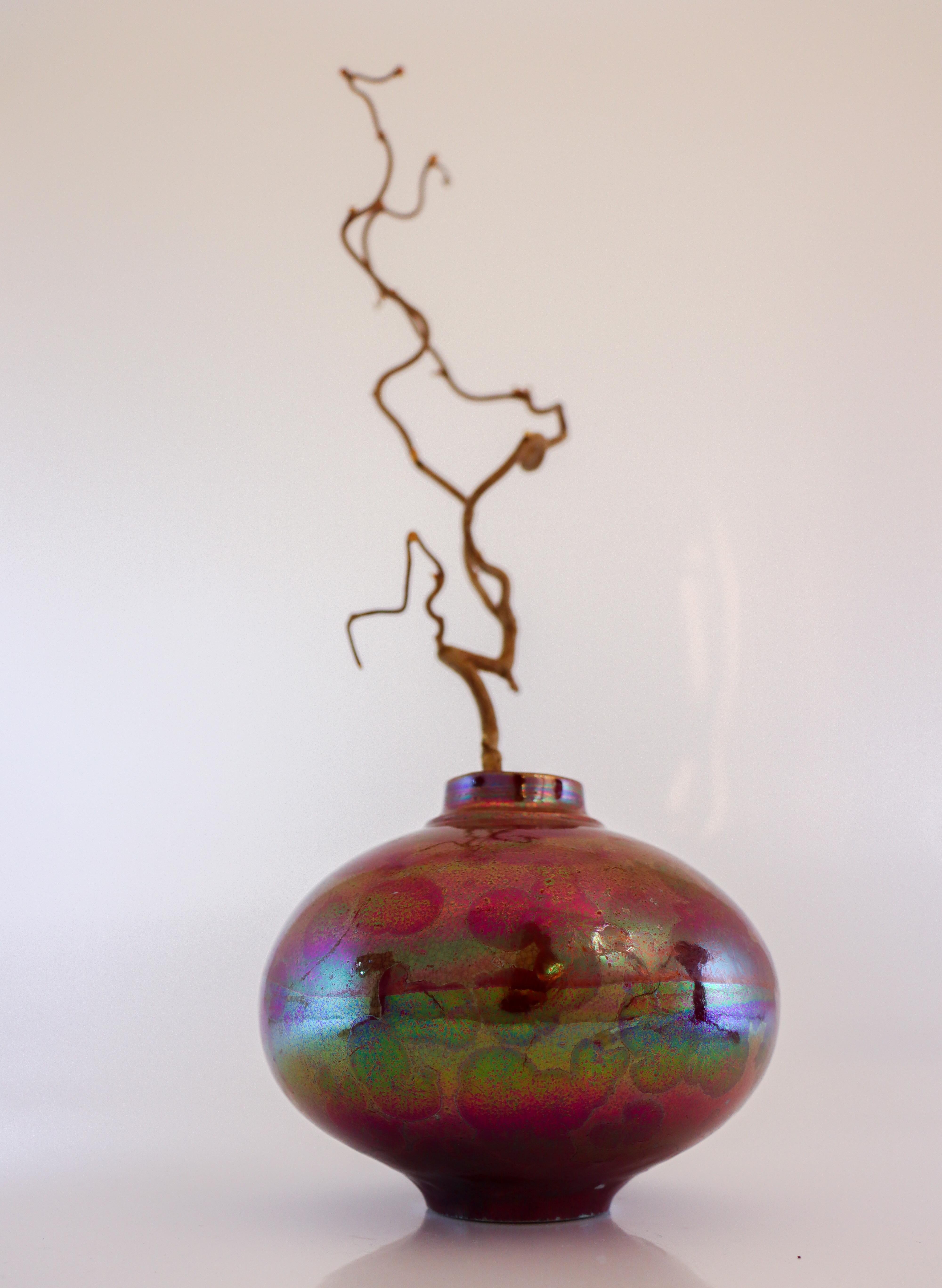 A glossy pink vase with a crystalline glaze designed by Isak Isaksson in Sweden. The vase is 12 cm (4.8