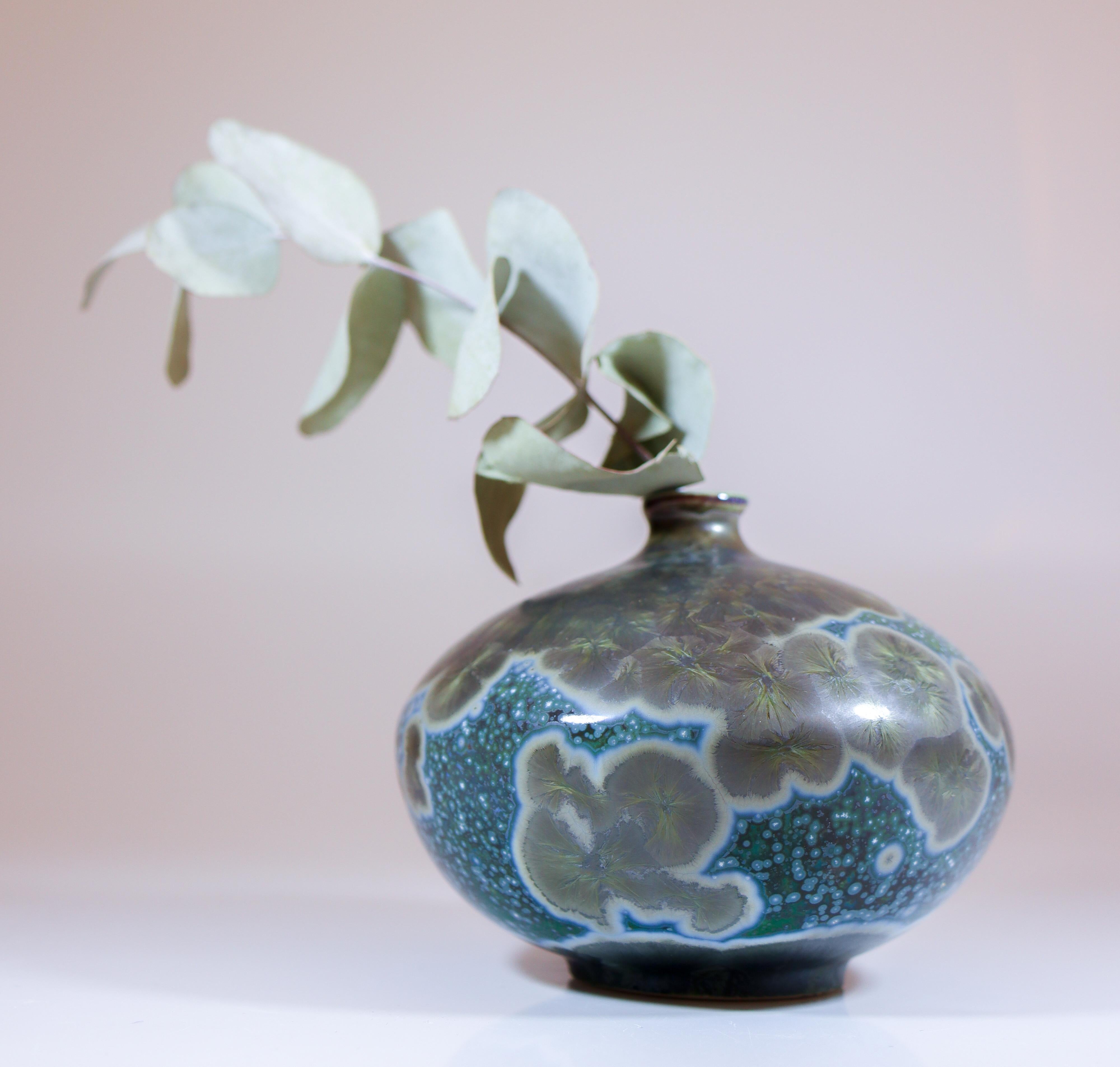 A green vase with a stunning crystalline glaze designed by Isak Isaksson in Sweden. The vase is 9 cm (3.6