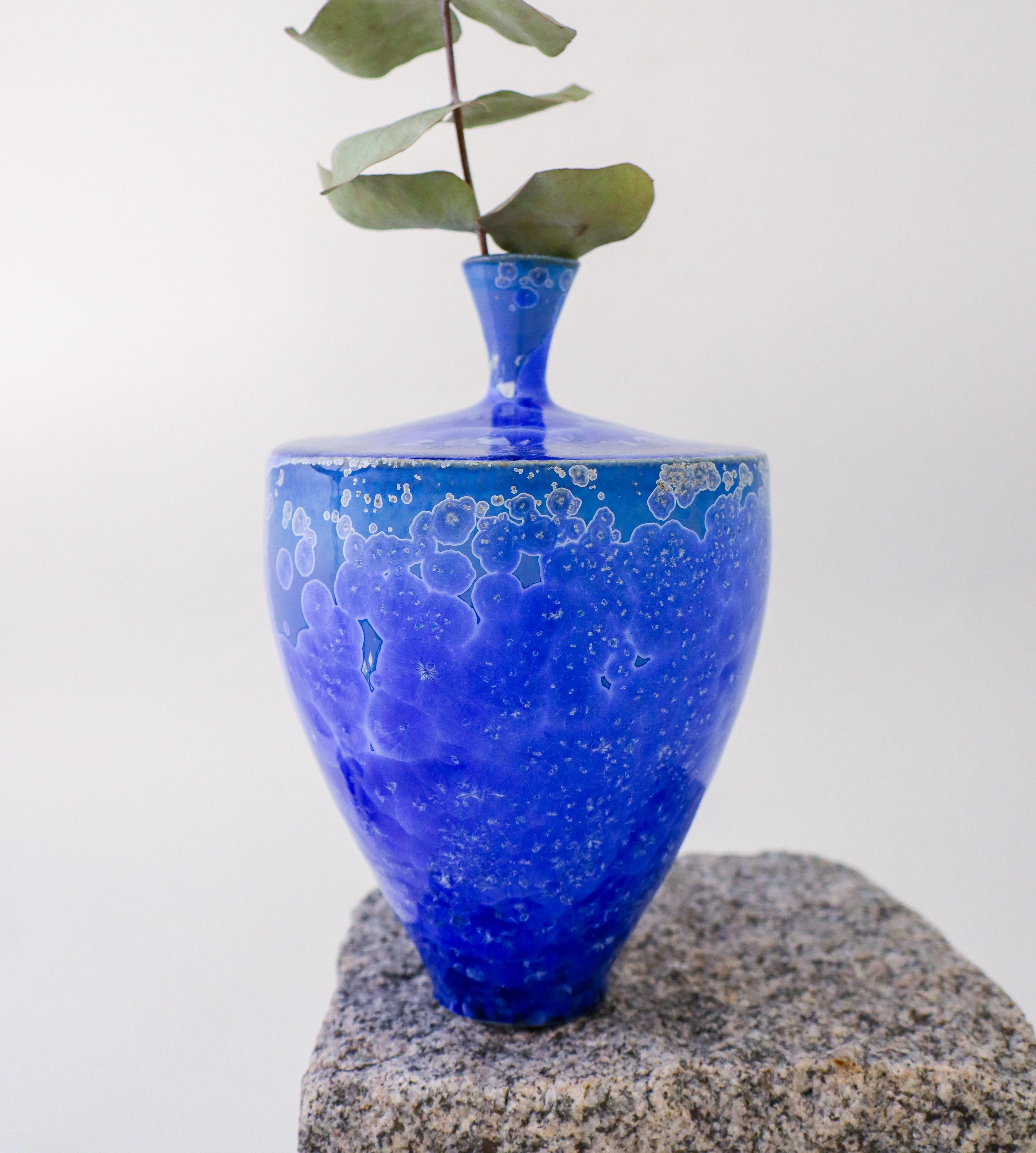 A deep blue vase with a lovely crystalline glaze designed by Isak Isaksson in Sweden. The vase is 18.5 cm (7.4