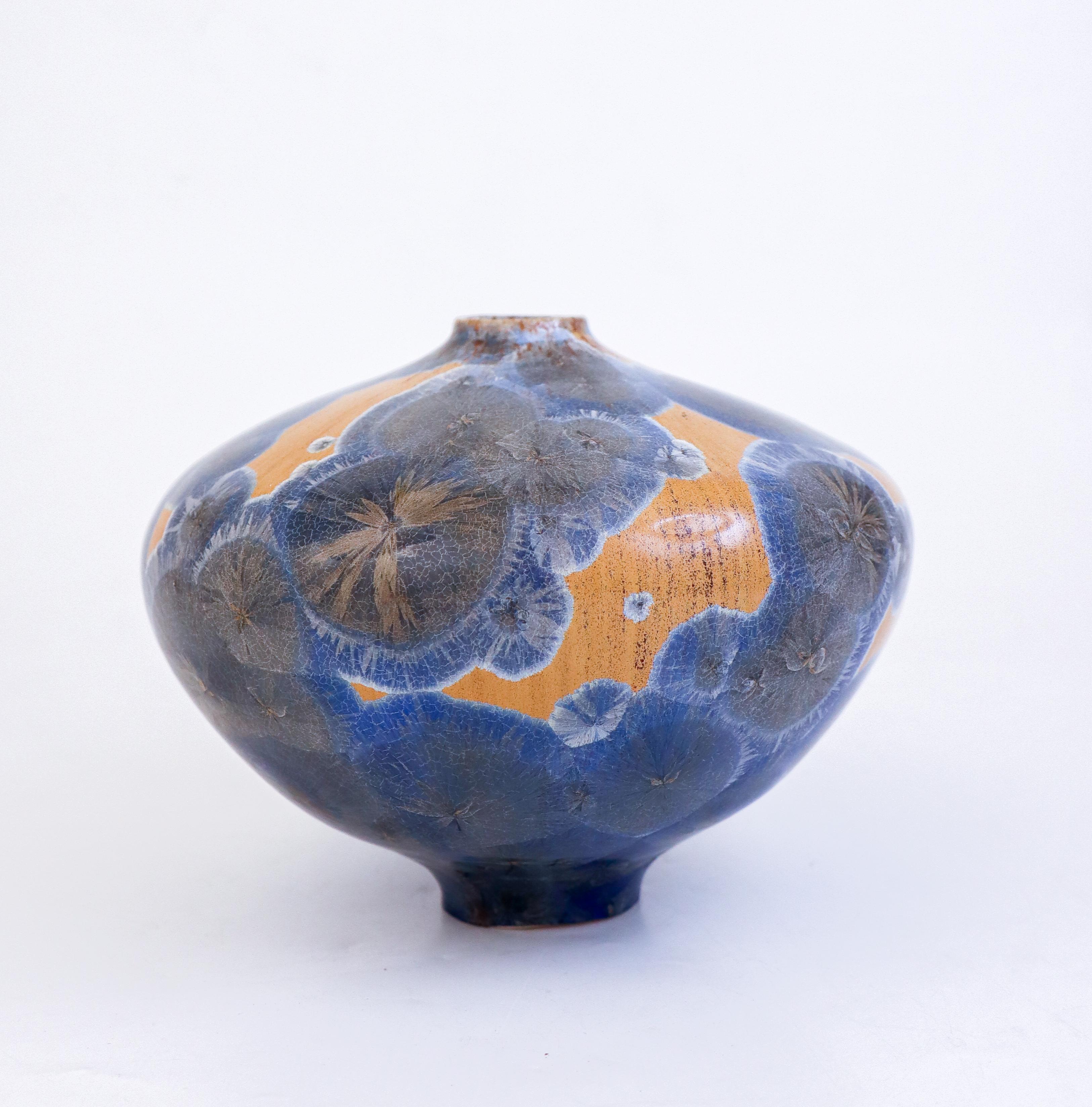 A gold/gray/blue vase with a lovely crystalline glaze designed by Isak Isaksson in Sweden. The vase is 13 cm (5.2