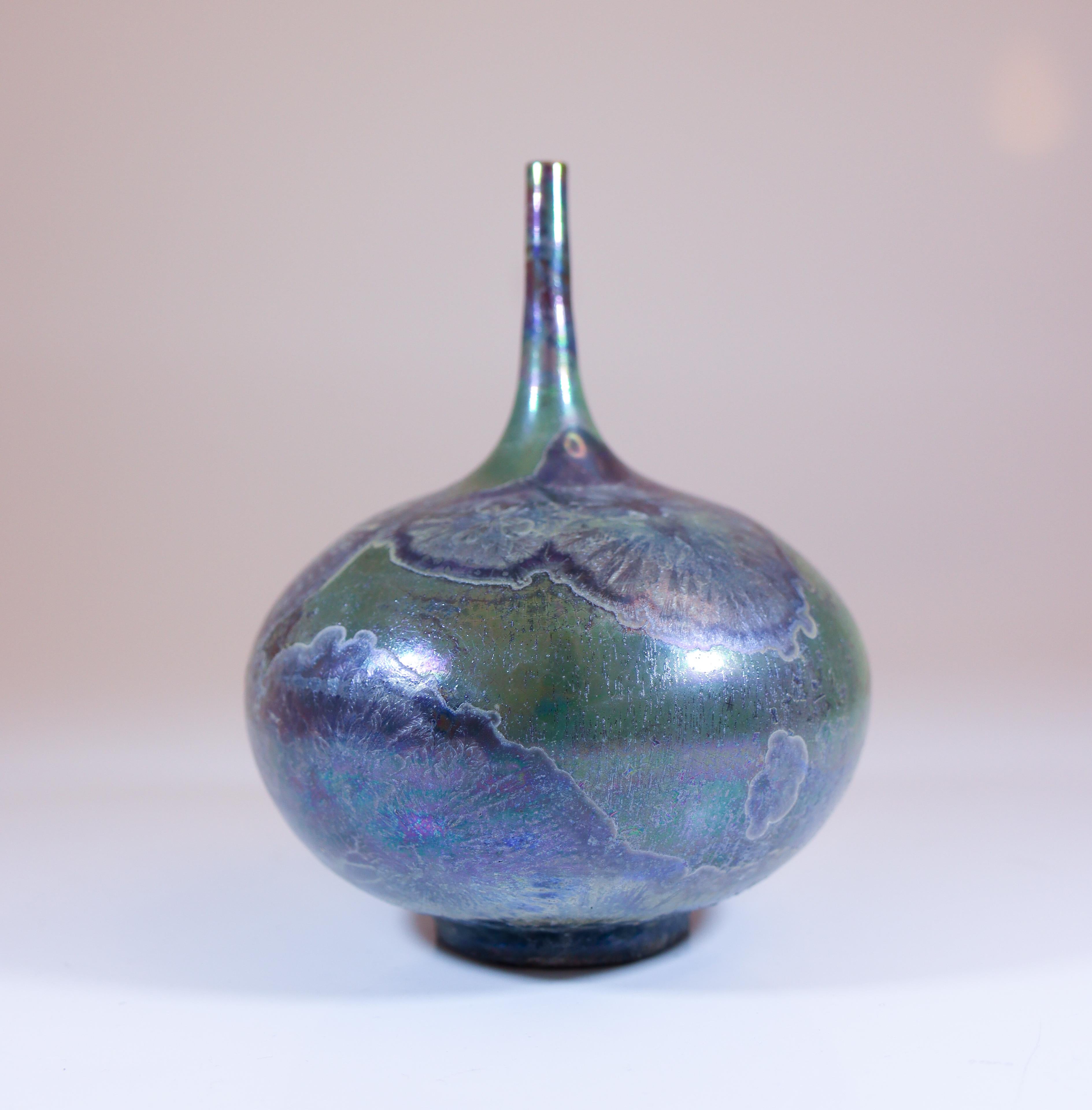 A green vase with a stunning crystalline glaze designed by Isak Isaksson in Sweden. The vase is 12 cm (4.8