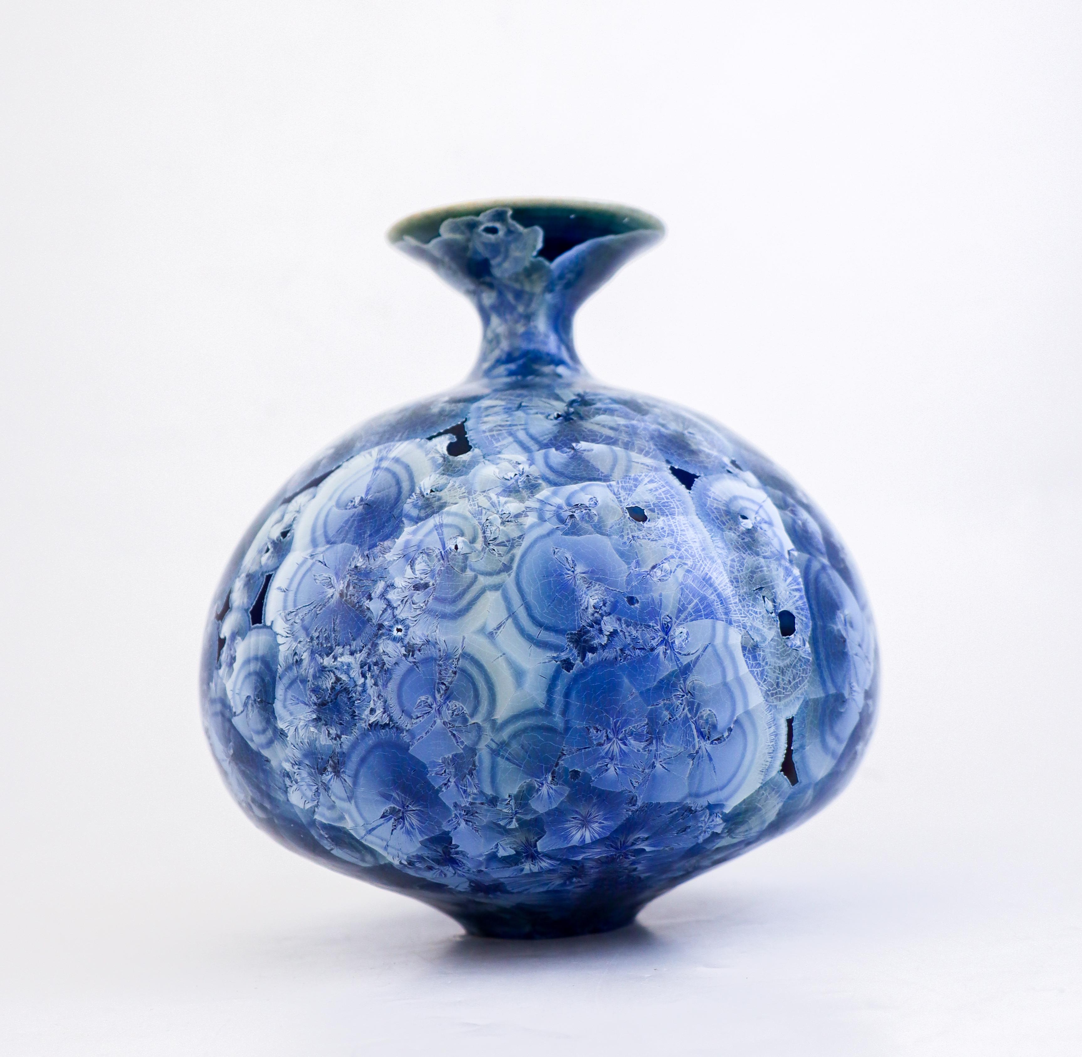 A large lovely blue vase with a stunning crystalline glaze designed by Isak Isaksson in Sweden. The vase is 17.5 cm (7