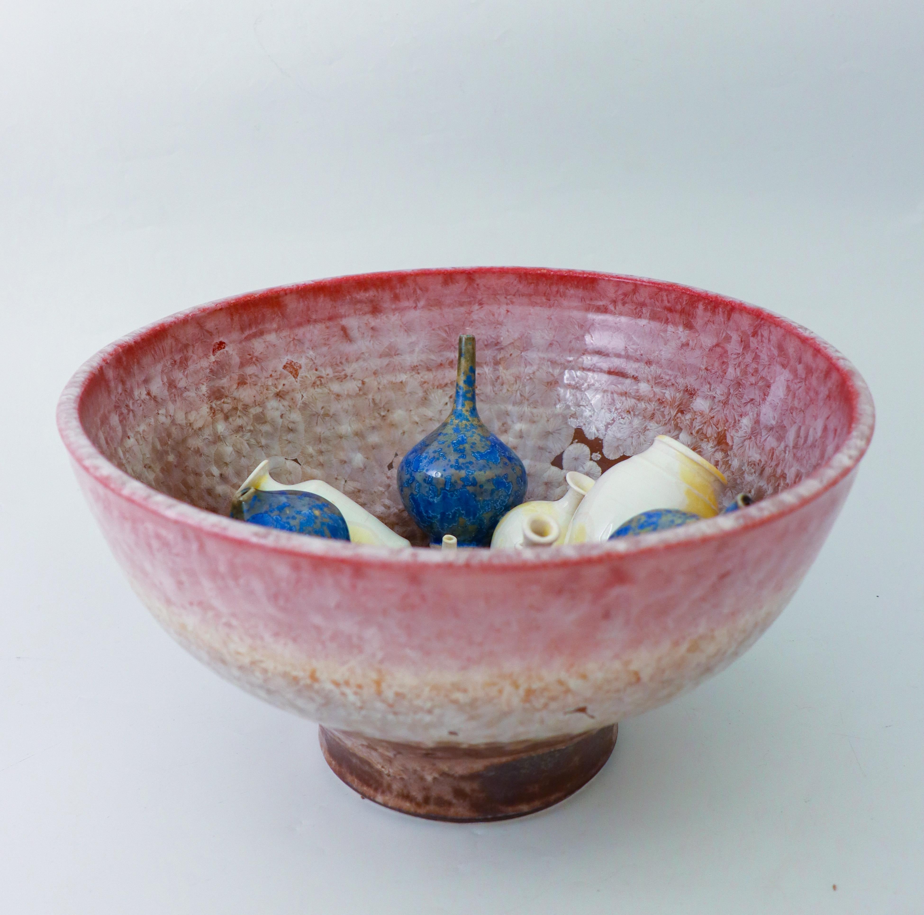 A lovely sculpture in the form of a bowl with smaller miniature vases fixed on the inside of the bowl. It comes with a lovely crystalline glaze designed by Isak Isaksson in Sweden. The bowl is 32 cm (12,8