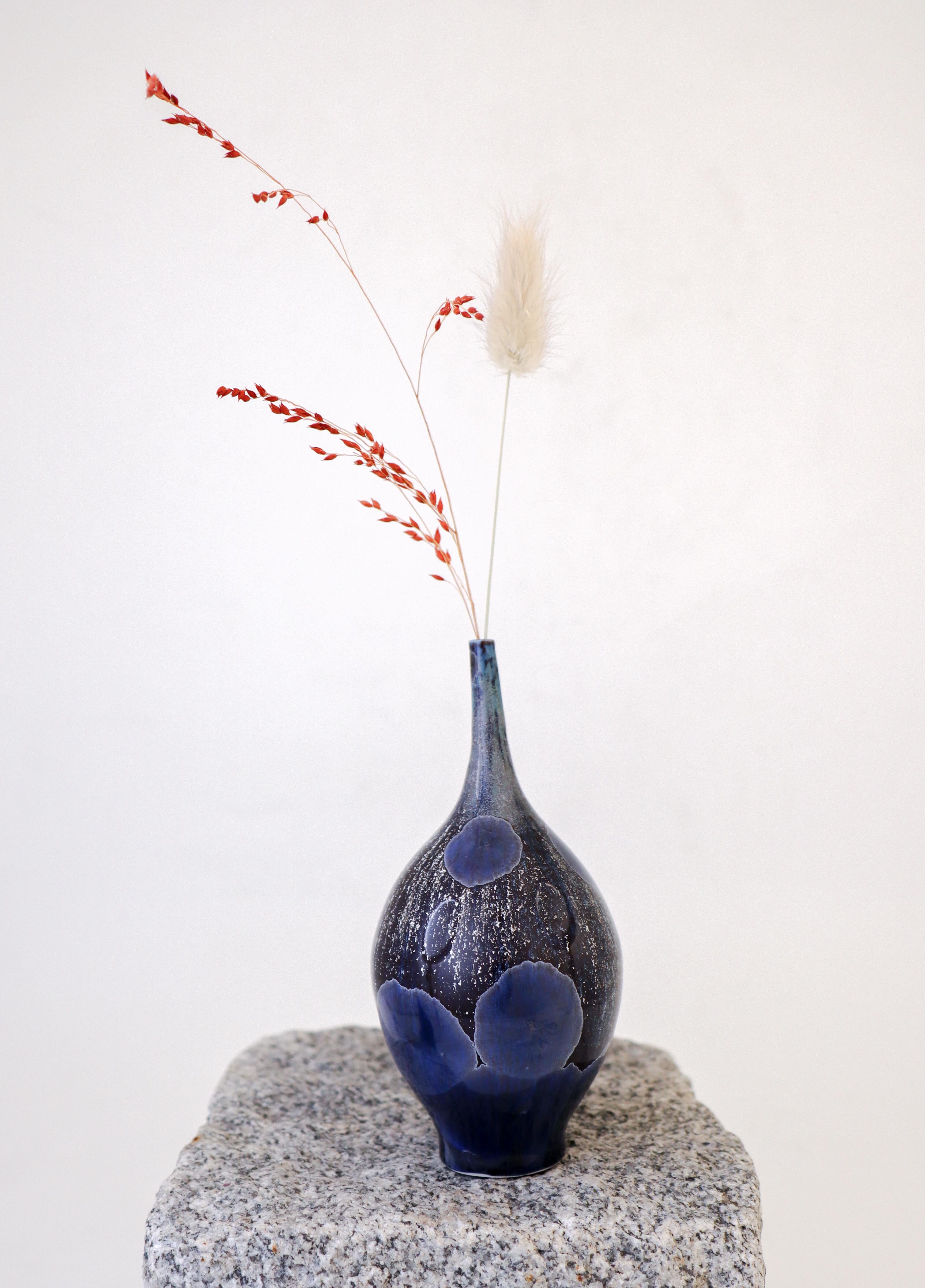 A metallic blue / space blue vase with a lovely crystalline glaze designed by Isak Isaksson in Sweden. The vase is 14.5 cm (5.8