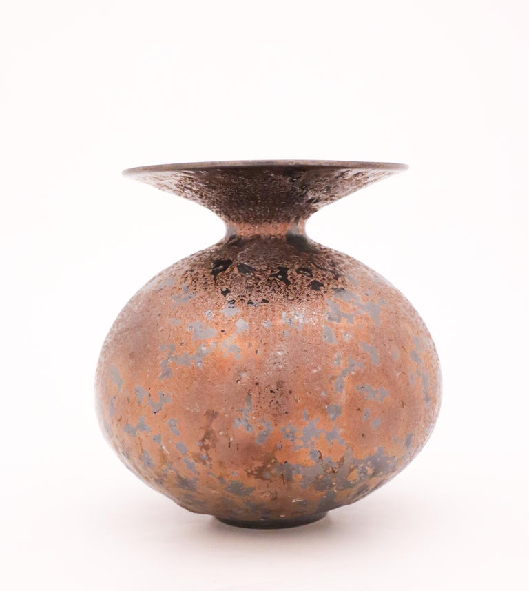 Just a lovely and unique vase in a shiny brown/golden crystalline glaze designed by the contemporary Swedish artist Isak Isaksson in his own studio. When light hits it, the glaze sparkles. The vase is 15 cm (6