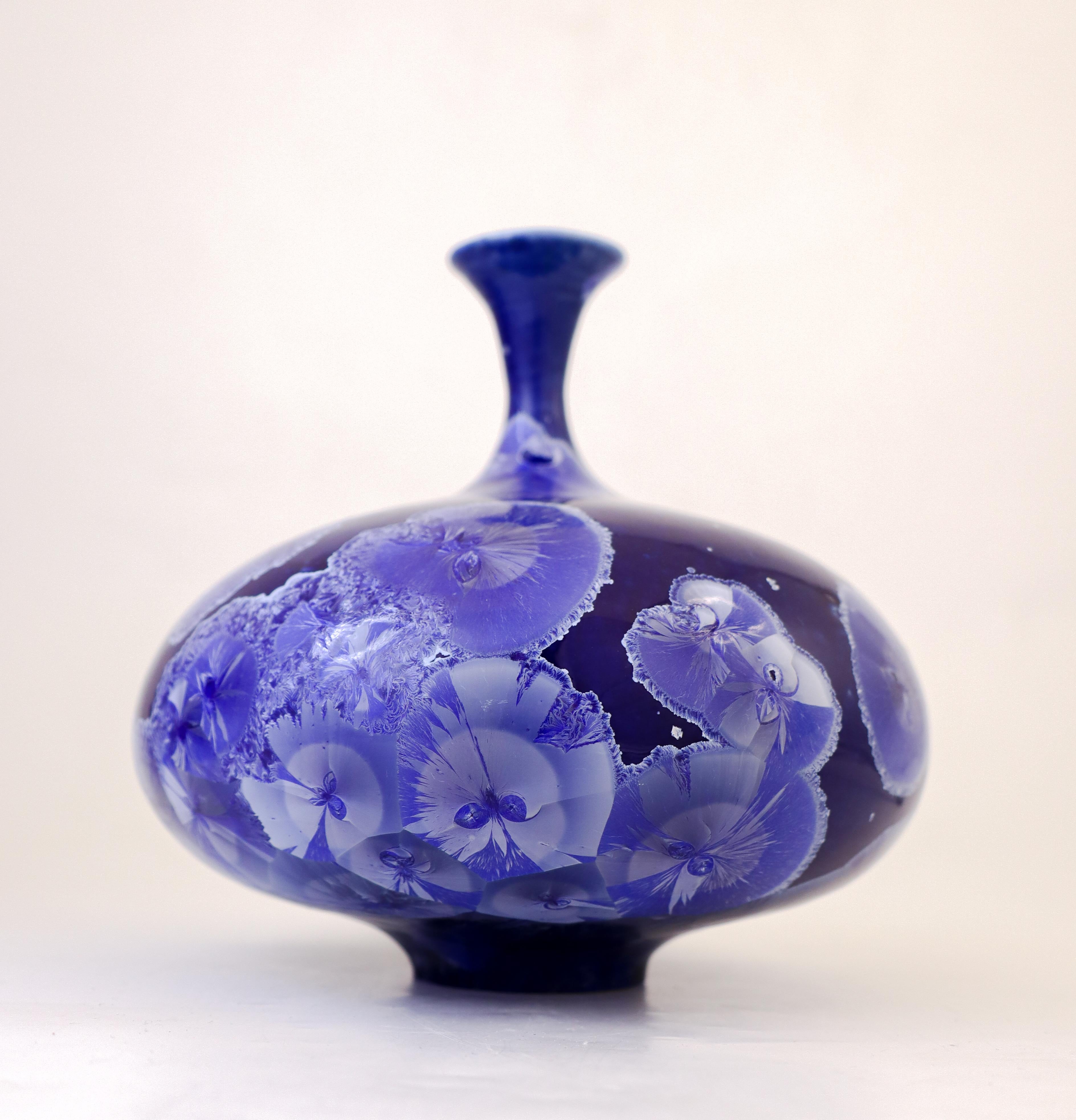 A blue vase with a stunning crystalline glaze and a lovely shape designed by Isak Isaksson in Sweden. The vase is 16 cm (6.4
