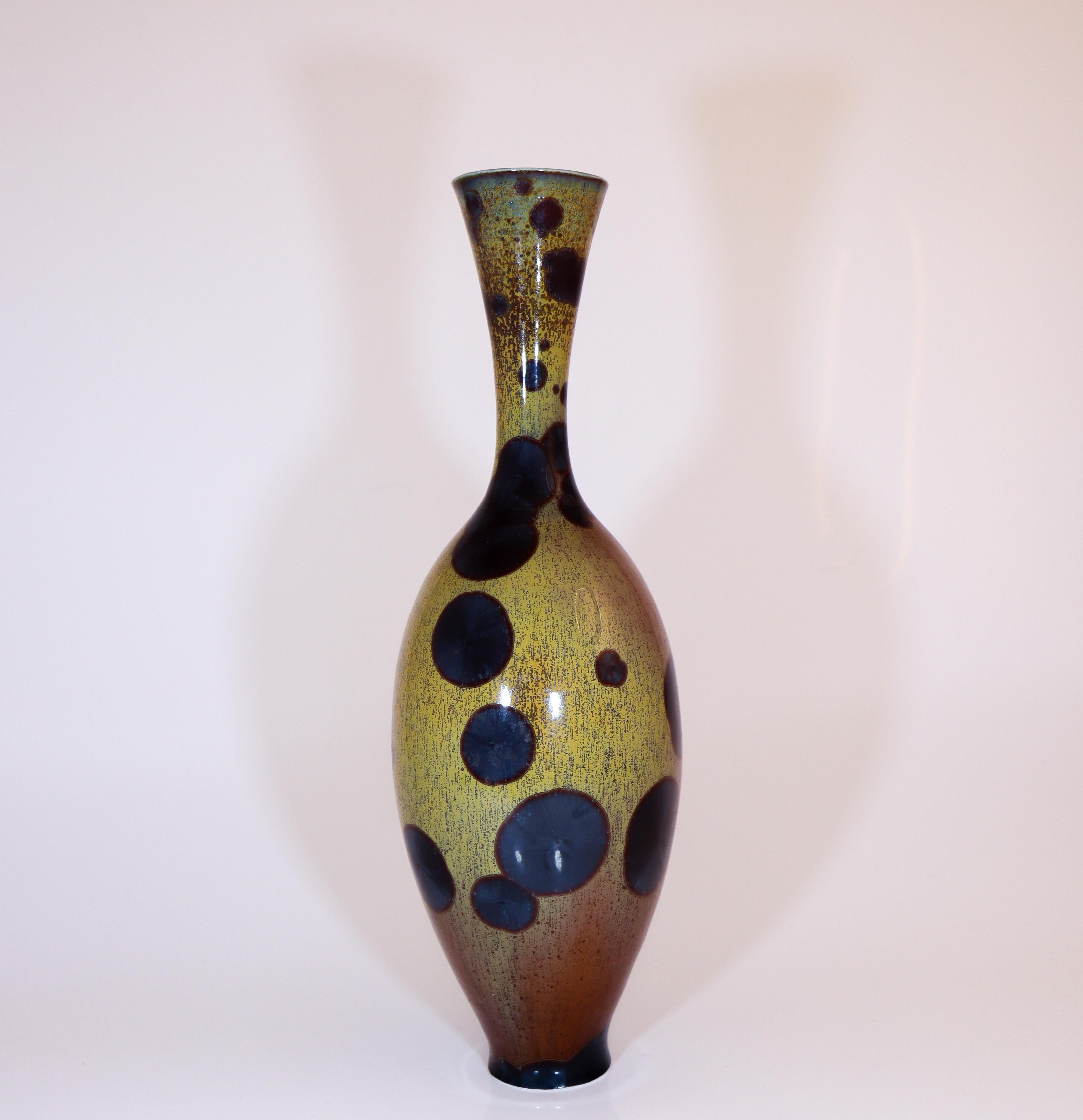 A multicolored vase with a crystalline glaze designed by Isak Isaksson in Sweden. The vase is 30 cm (12