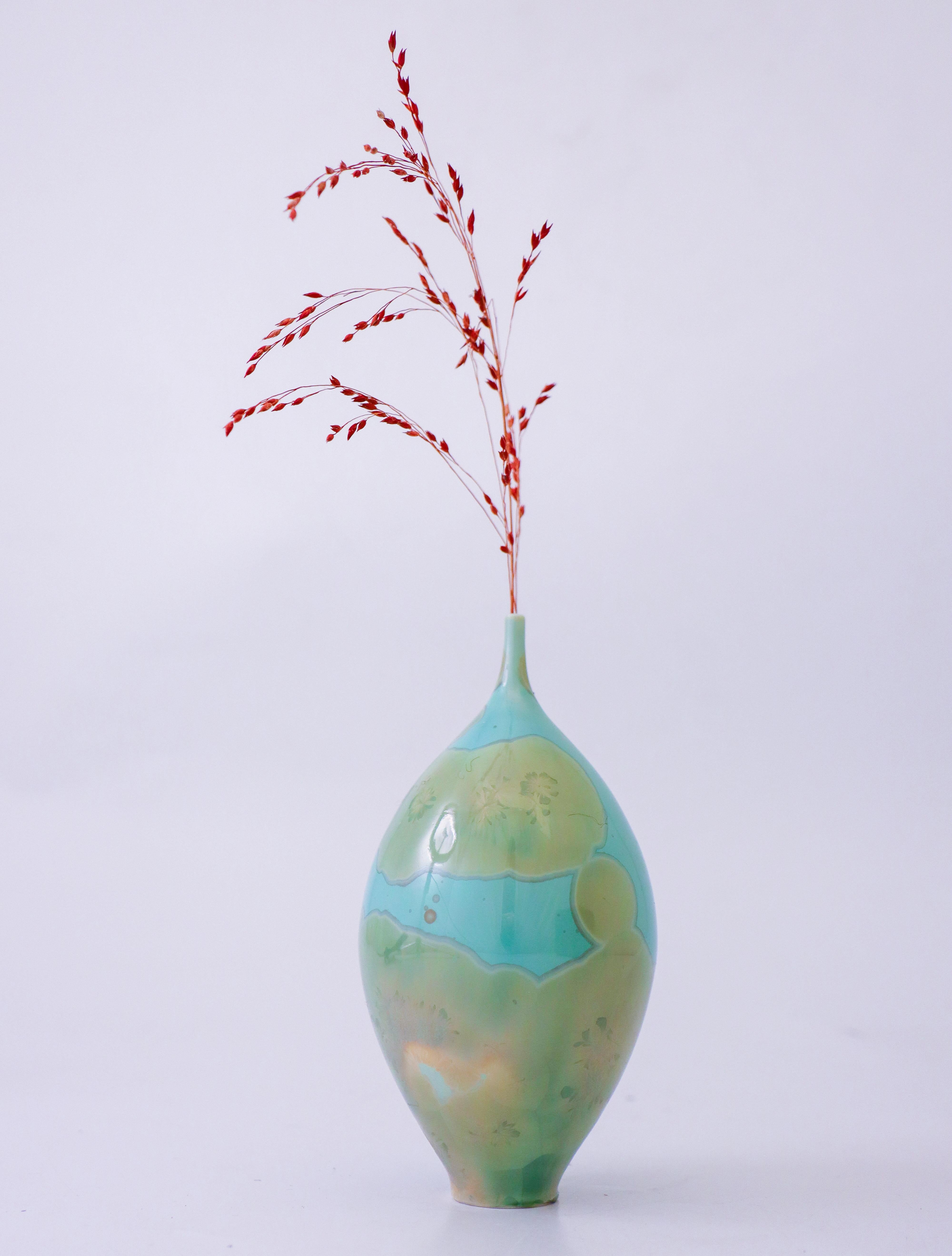 A beautiful turquoise vase with a green crystalline glaze designed by Isak Isaksson in Sweden. The vase is 14,5 cm (5.8