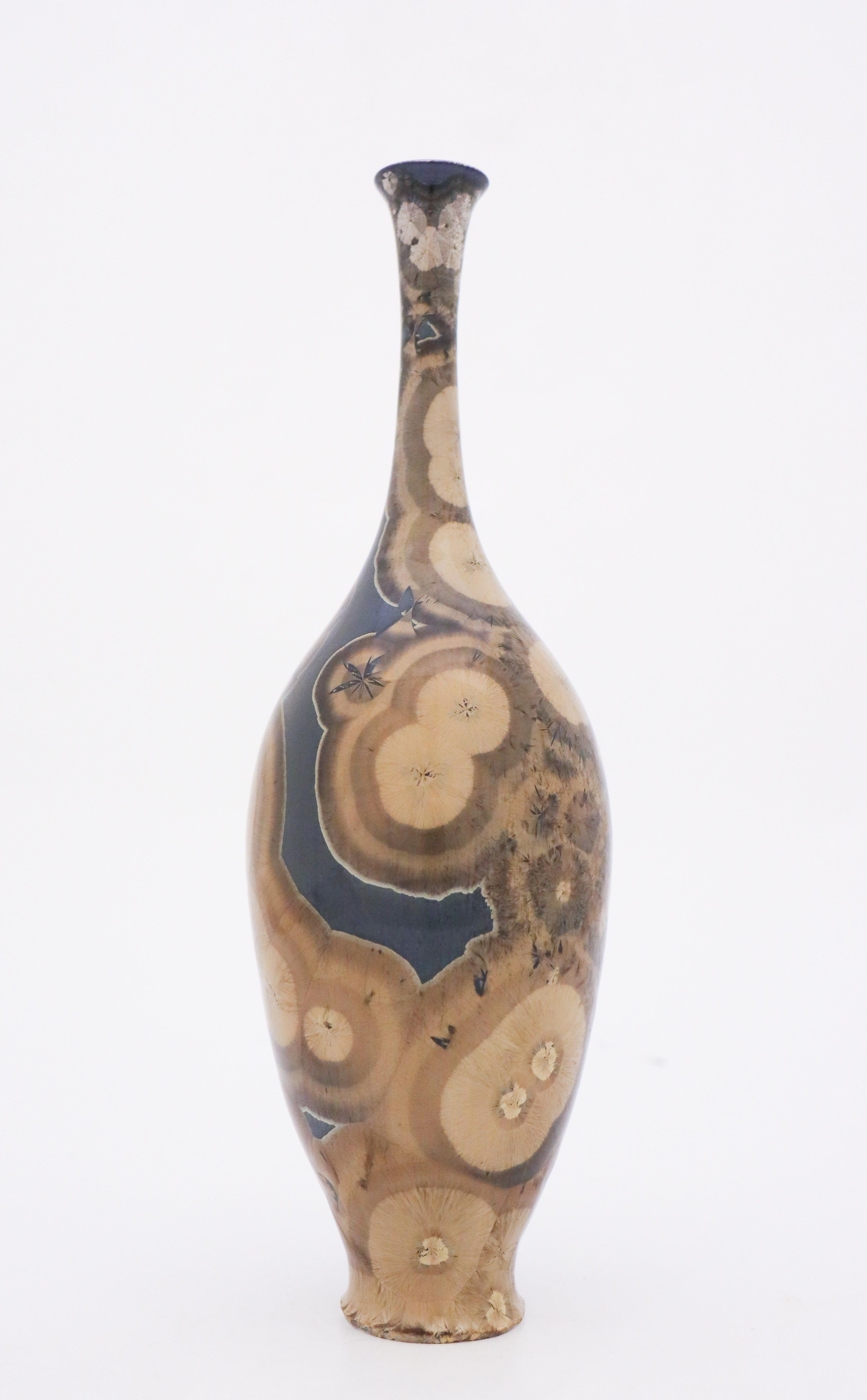 A unique vase in a Metal blue/brown-tone with a lovely crystalline glaze designed by the contemporary Swedish artist Isak Isaksson in his own studio. The vase is 27.5 cm (11