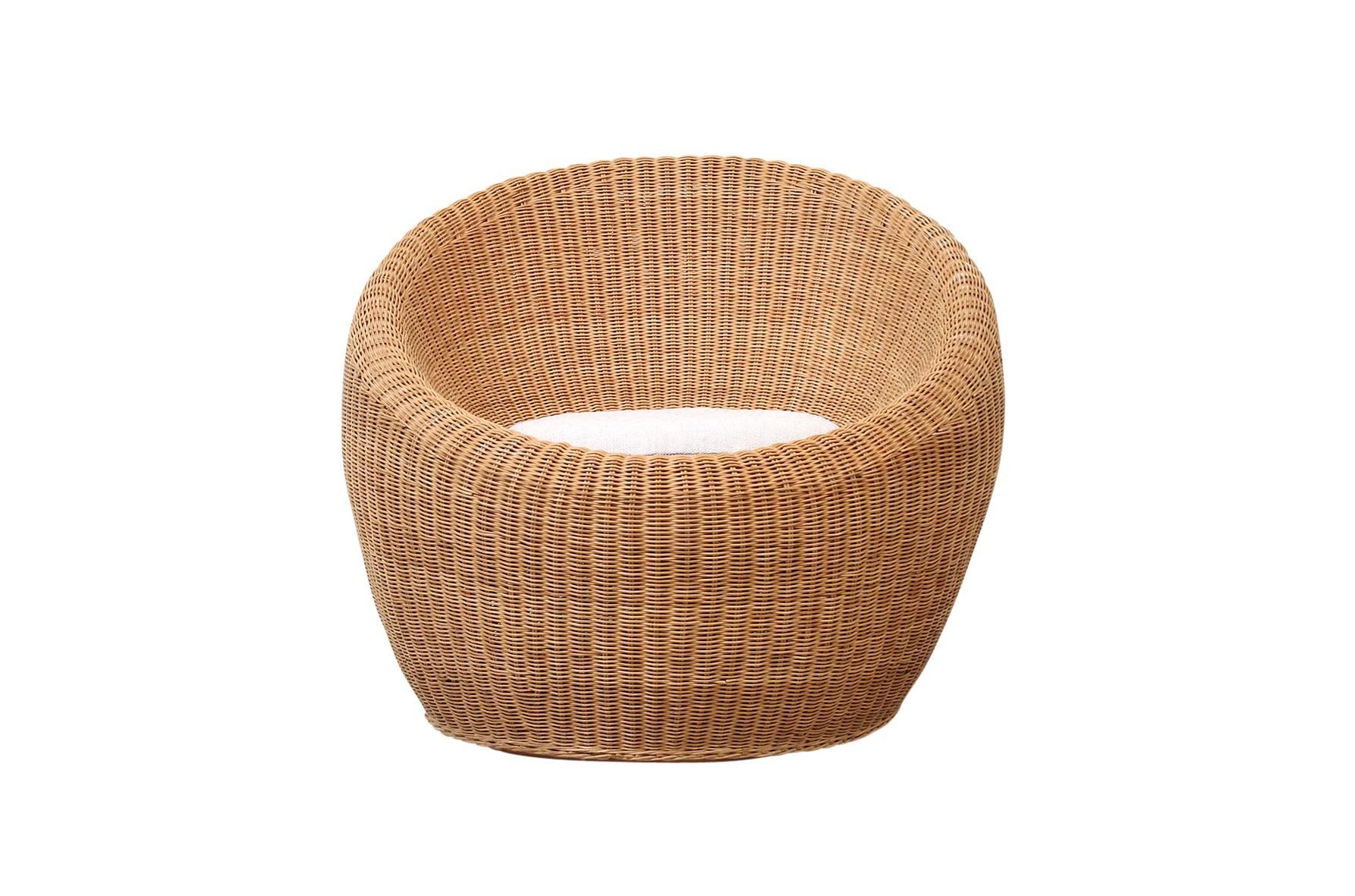 Rattan lounge chair with loose upholstered cushion designed by Japanese designer Isamu Kenmochi for Yamakawa Rattan. An example of this chair design is pictured in 